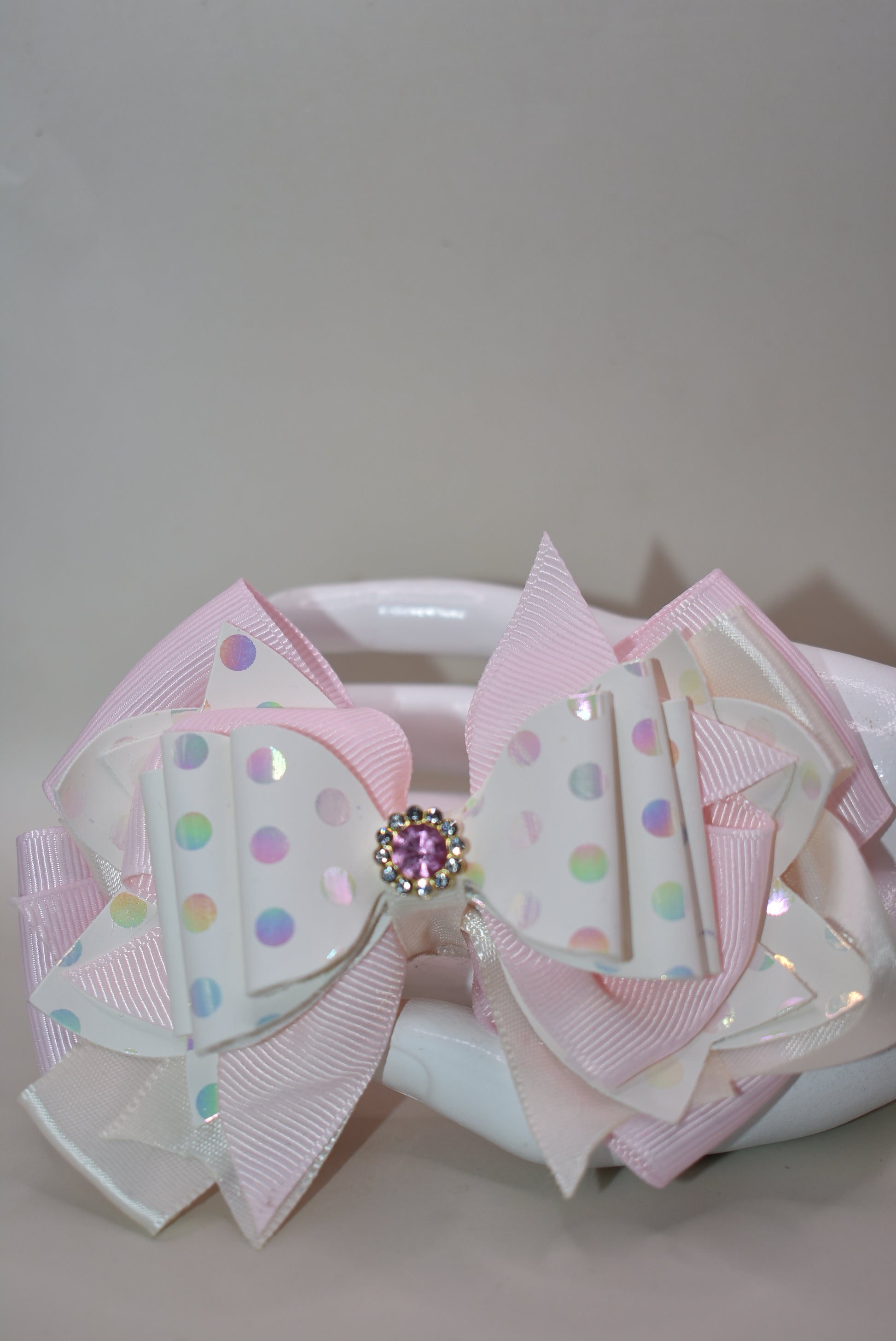 ✨ Introducing the prettiest pink bow that'll make any little girl's heart skip a beat! 💕 This adorable accessory features layers upon layers of luxurious ribbon and faux leather, creating a dimensional look that's absolutely stunning. Whether you're dressing up for a special occasion or adding a touch of charm to everyday wear, this versatile bow does it all. 👑 The sparkling crystal charm perched on top adds that extra dash of magic and elegance. Each piece is truly one-of-a-kind, making it a special trea