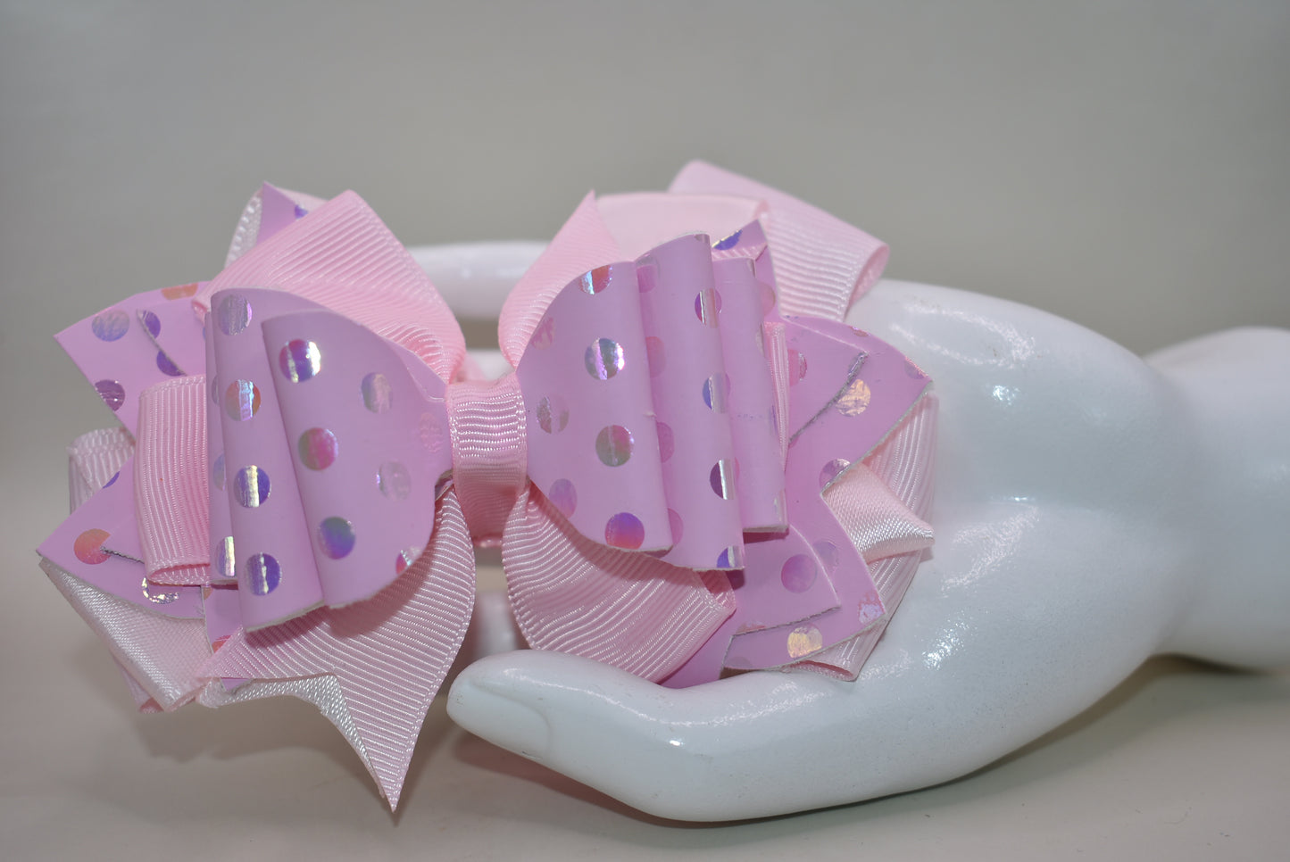 Get ready to turn heads with this adorable pink bow that's pure charm! 🎀 Layered with mixed ribbons and luxe faux leather, it features a shimmering polka dot design that adds the perfect pop to any outfit. ✨ The wrapped alligator clip makes it super easy to clip on and off whenever you want. Pretty in pink has never looked so good! 💕