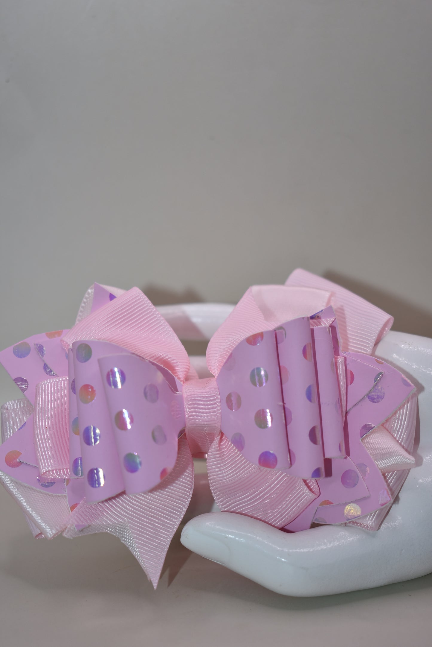 Get ready to turn heads with this adorable pink bow that's pure charm! 🎀 Layered with mixed ribbons and luxe faux leather, it features a shimmering polka dot design that adds the perfect pop to any outfit. ✨ The wrapped alligator clip makes it super easy to clip on and off whenever you want. Pretty in pink has never looked so good! 💕