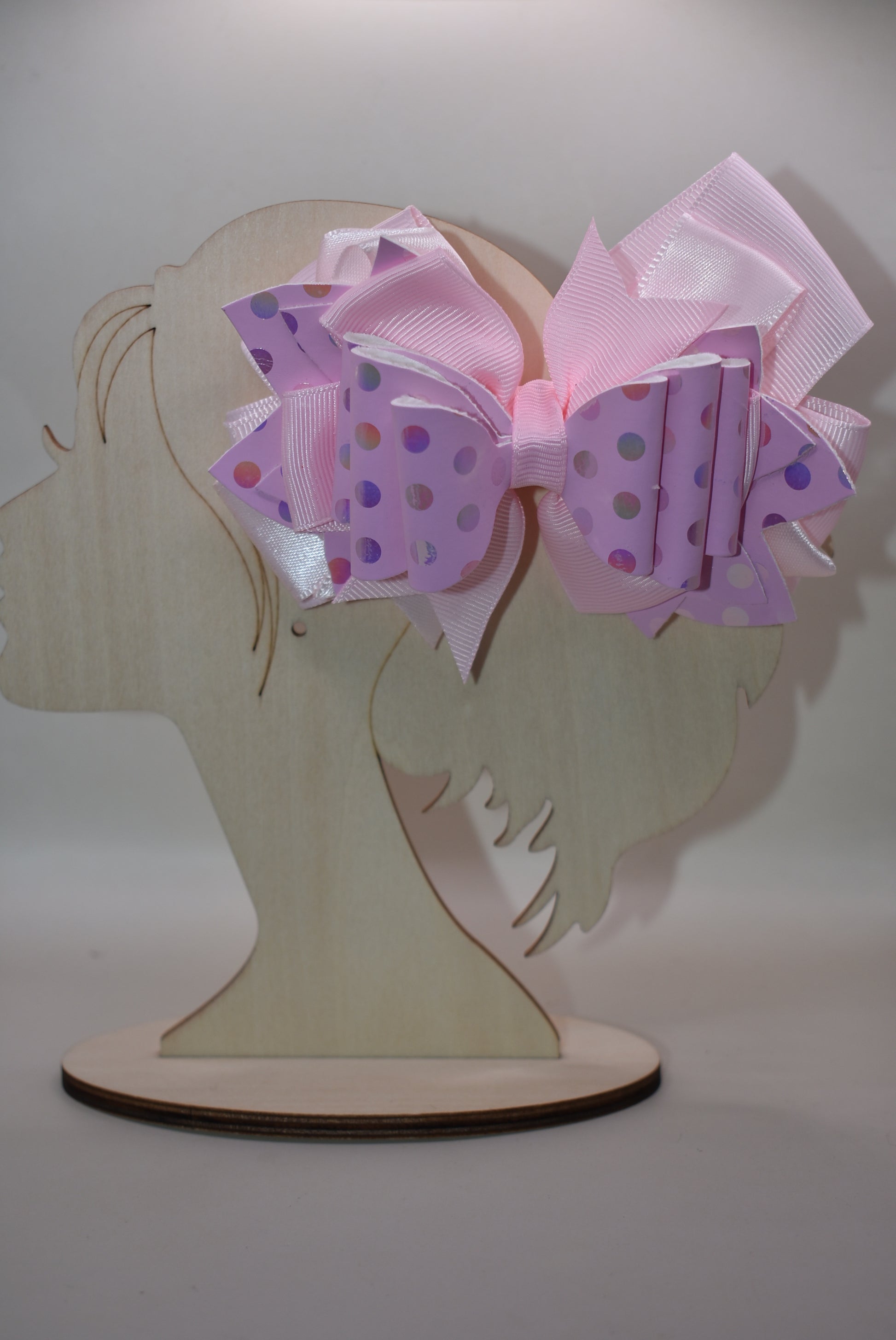 Get ready to turn heads with this adorable pink bow that's pure charm! 🎀 Layered with mixed ribbons and luxe faux leather, it features a shimmering polka dot design that adds the perfect pop to any outfit. ✨ The wrapped alligator clip makes it super easy to clip on and off whenever you want. Pretty in pink has never looked so good! 💕