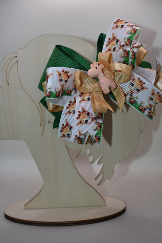 Meet your new favorite hair accessory! 🦒 This adorable giraffe bow features layered ribbons in charming giraffe print mixed with a complementary color for extra visual appeal. A precious giraffe charm sits proudly on top, adding that perfect finishing touch. The wrapped alligator clip on the back makes it super easy to secure in place, so your little one can rock this cute look all day long. Perfect for adding a splash of personality to any hairstyle! ✨🎀