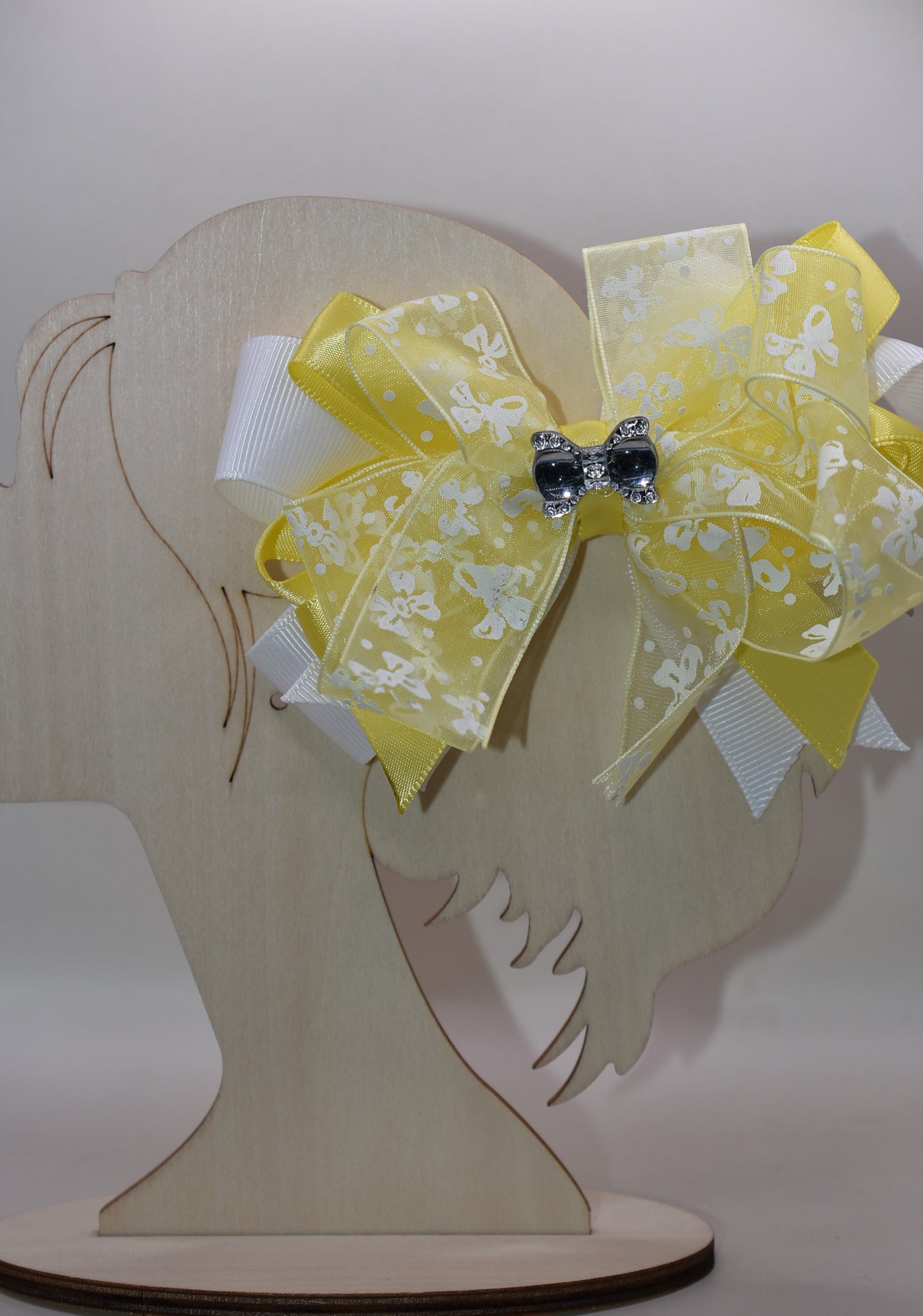 ✨ Introducing Nana's Collection 70 – a sunshine-bright bow that's as charming as it is gorgeous! 🎀 This delightful accessory features layers upon layers of mixed fabric ribbon, creating beautiful texture and dimension. Topped with a delicate bow-themed ribbon and finished with a sparkling crystal bow charm, it's the perfect finishing touch for any look. Whether you're dressing up a hairstyle, gift, or outfit, this cheerful yellow bow brings instant elegance and whimsy. 💛 A little luxury that makes a big i