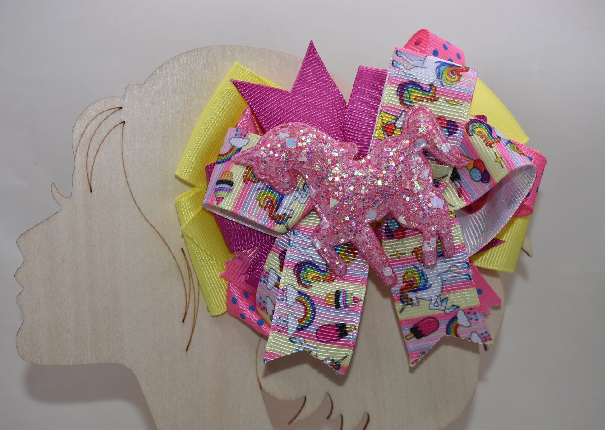 ✨ Meet your new favorite hair accessory! This one-of-a-kind bow features a gorgeous glitter unicorn figure crowned with unicorn rainbow ribbon. 🦄 Layers upon layers of vibrant, multi-colored ribbons create a whimsical masterpiece that's sure to turn heads. The secure alligator clip keeps your style in place all day long, so you can sparkle and shine from sunrise to sunset. 🎀💫 Pure magic for unicorn lovers everywhere!