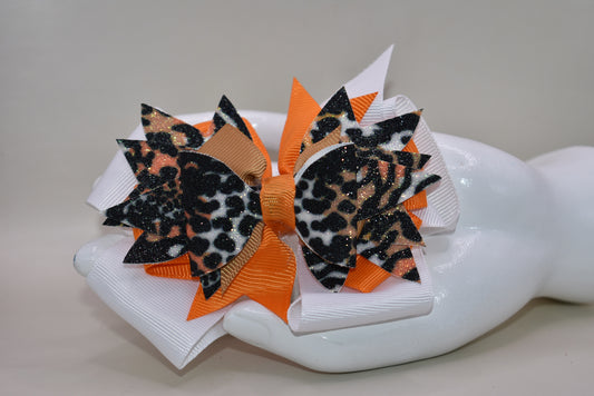 🐆 Get ready to roar with style! This fabulous leopard print faux leather bow features vibrant layers of colorful ribbon that'll make heads turn. The playful animal print mixed with those eye-catching ribbon details creates the perfect pop of personality for any look. Secured with a wrapped alligator clip on the back, it's easy to style and built to stay put. A fun, fierce accessory that's bound to become an instant favorite! 🎀✨