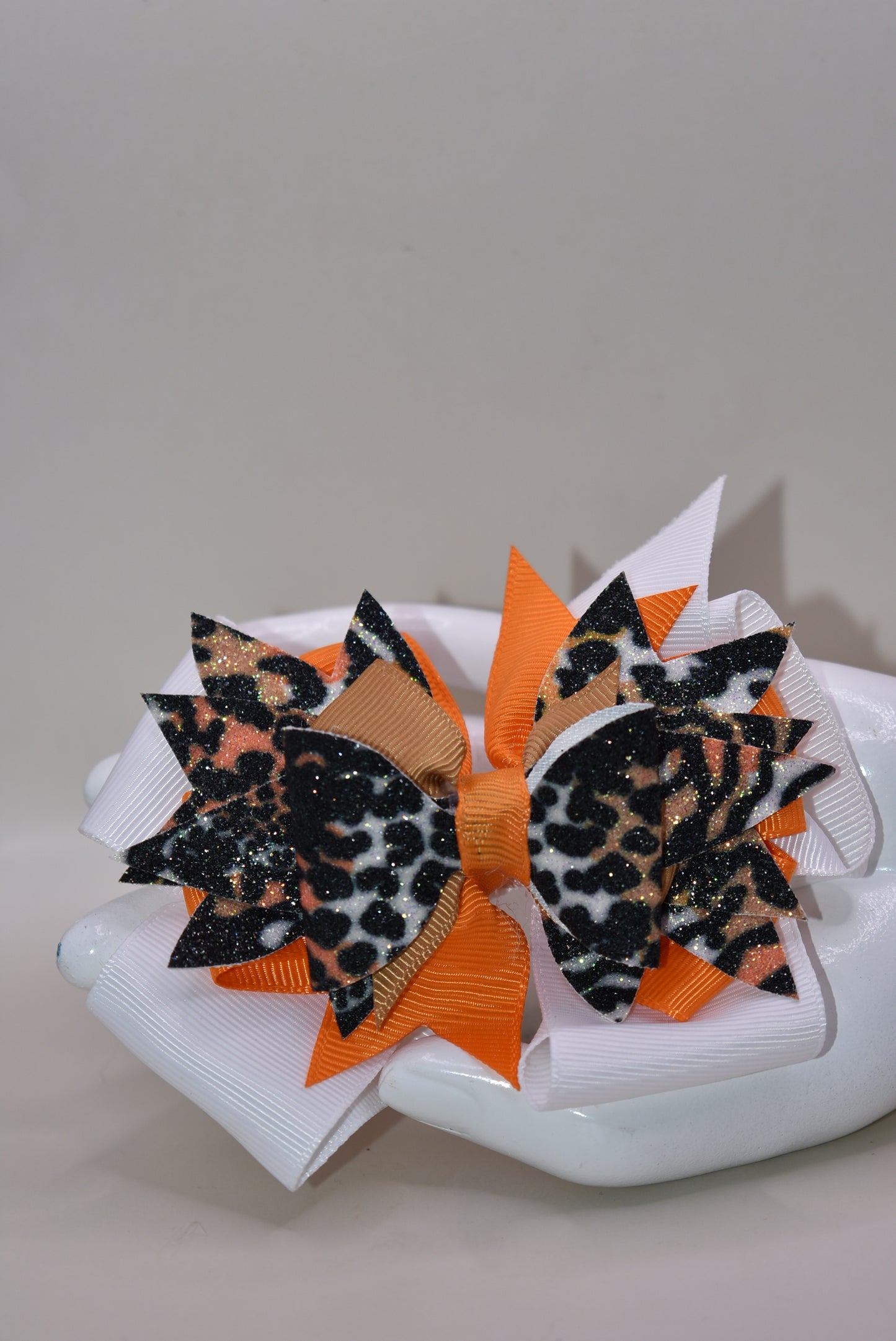 🐆 Get ready to roar with style! This fabulous leopard print faux leather bow features vibrant layers of colorful ribbon that'll make heads turn. The playful animal print mixed with those eye-catching ribbon details creates the perfect pop of personality for any look. Secured with a wrapped alligator clip on the back, it's easy to style and built to stay put. A fun, fierce accessory that's bound to become an instant favorite! 🎀✨