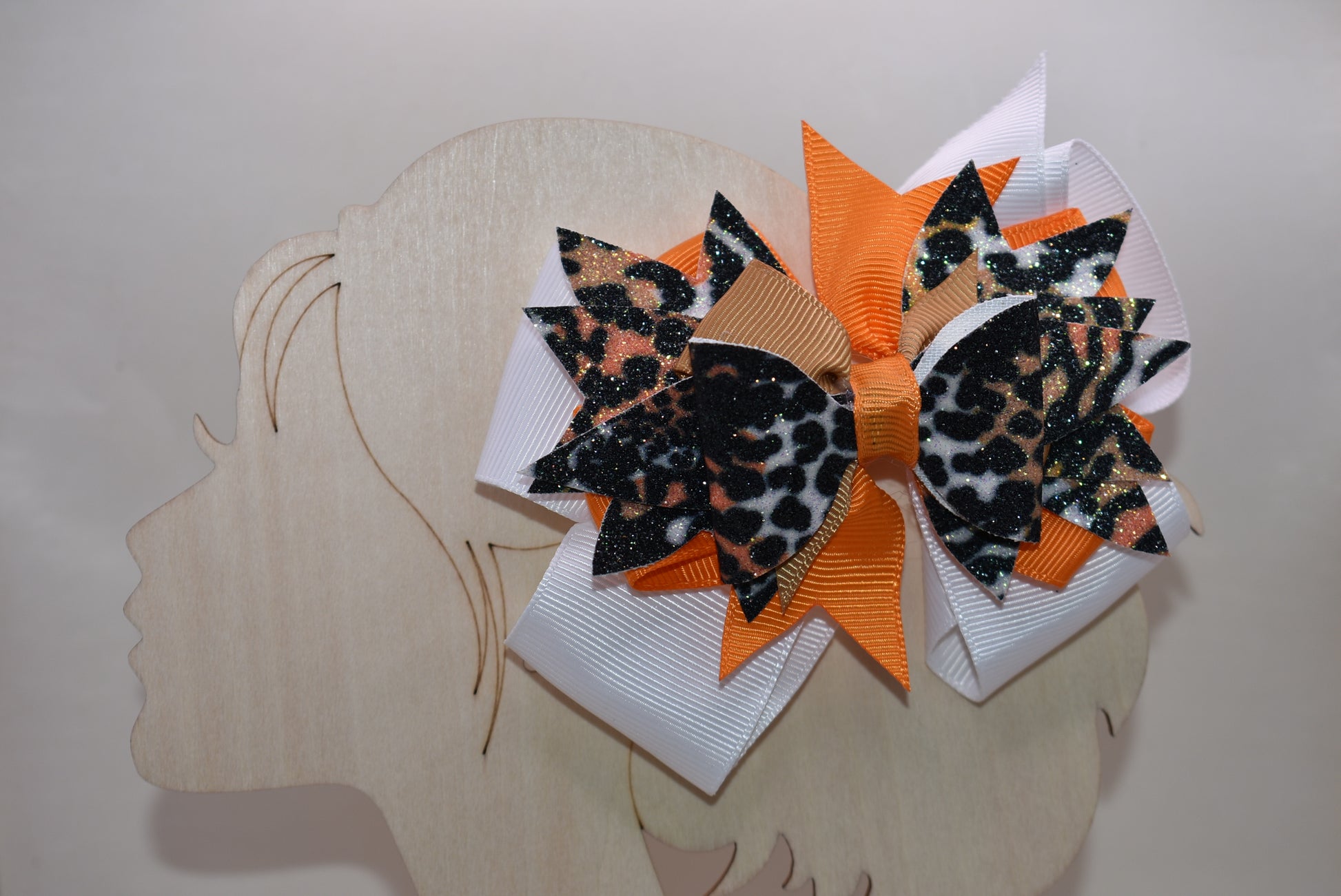 🐆 Get ready to roar with style! This fabulous leopard print faux leather bow features vibrant layers of colorful ribbon that'll make heads turn. The playful animal print mixed with those eye-catching ribbon details creates the perfect pop of personality for any look. Secured with a wrapped alligator clip on the back, it's easy to style and built to stay put. A fun, fierce accessory that's bound to become an instant favorite! 🎀✨