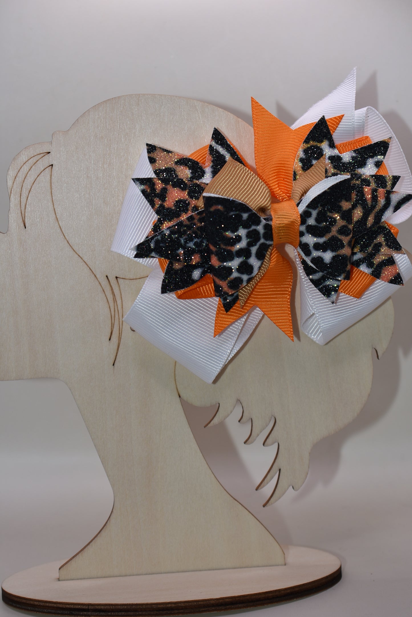 🐆 Get ready to roar with style! This fabulous leopard print faux leather bow features vibrant layers of colorful ribbon that'll make heads turn. The playful animal print mixed with those eye-catching ribbon details creates the perfect pop of personality for any look. Secured with a wrapped alligator clip on the back, it's easy to style and built to stay put. A fun, fierce accessory that's bound to become an instant favorite! 🎀✨