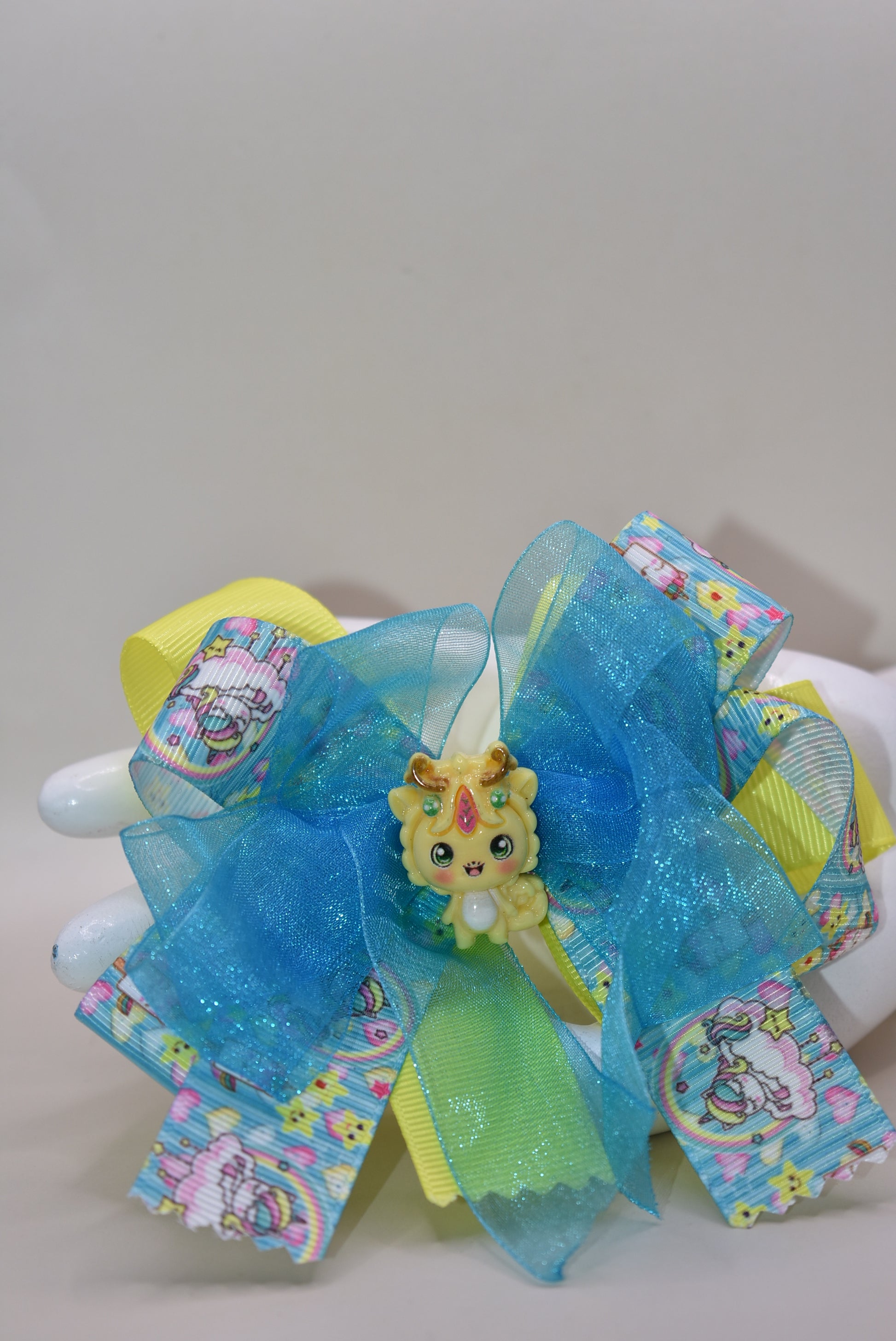 ✨ Get ready to add some magical flair to your hair! This one-of-a-kind unicorn bow features layers upon layers of gorgeous ribbon, beautifully accented with enchanting unicorn-themed ribbon and the sweetest little unicorn charms perched right on top. 🦄 The wrapped alligator clip makes it super easy to secure and wear all day long. Perfect for unicorn lovers who want to sprinkle a little extra sparkle into their style! 💫