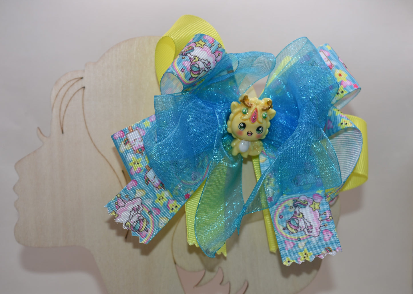✨ Get ready to add some magical flair to your hair! This one-of-a-kind unicorn bow features layers upon layers of gorgeous ribbon, beautifully accented with enchanting unicorn-themed ribbon and the sweetest little unicorn charms perched right on top. 🦄 The wrapped alligator clip makes it super easy to secure and wear all day long. Perfect for unicorn lovers who want to sprinkle a little extra sparkle into their style! 💫
