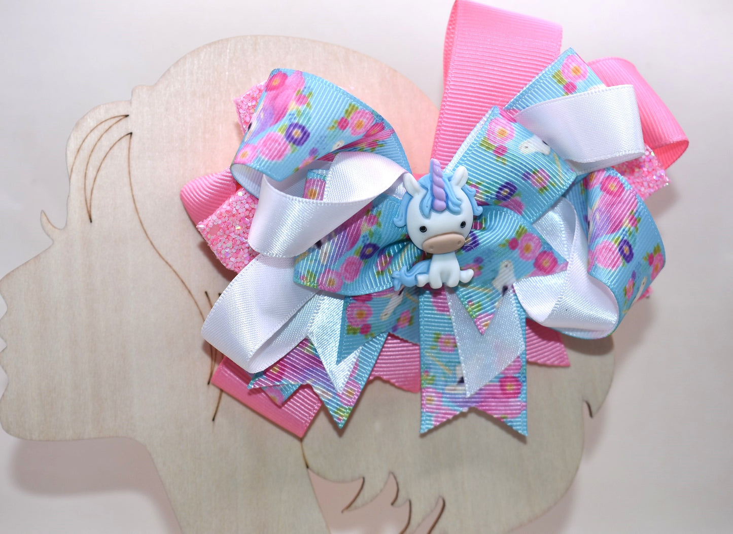 ✨ This adorable unicorn bow is a dreamy mix of soft pink and blue ribbons layered to perfection, featuring a special unicorn-themed ribbon that brings extra magic to the design. A precious little unicorn charm perches right on top, adding that extra touch of cuteness! 🦄 The wrapped alligator clip makes it super easy to wear all day long without any fuss. Perfect for adding a sprinkle of whimsy to any hairstyle! 💕🎀
