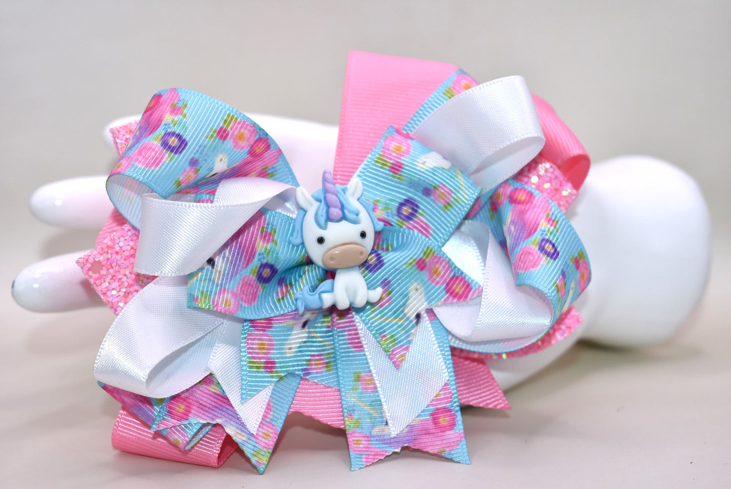 ✨ This adorable unicorn bow is a dreamy mix of soft pink and blue ribbons layered to perfection, featuring a special unicorn-themed ribbon that brings extra magic to the design. A precious little unicorn charm perches right on top, adding that extra touch of cuteness! 🦄 The wrapped alligator clip makes it super easy to wear all day long without any fuss. Perfect for adding a sprinkle of whimsy to any hairstyle! 💕🎀