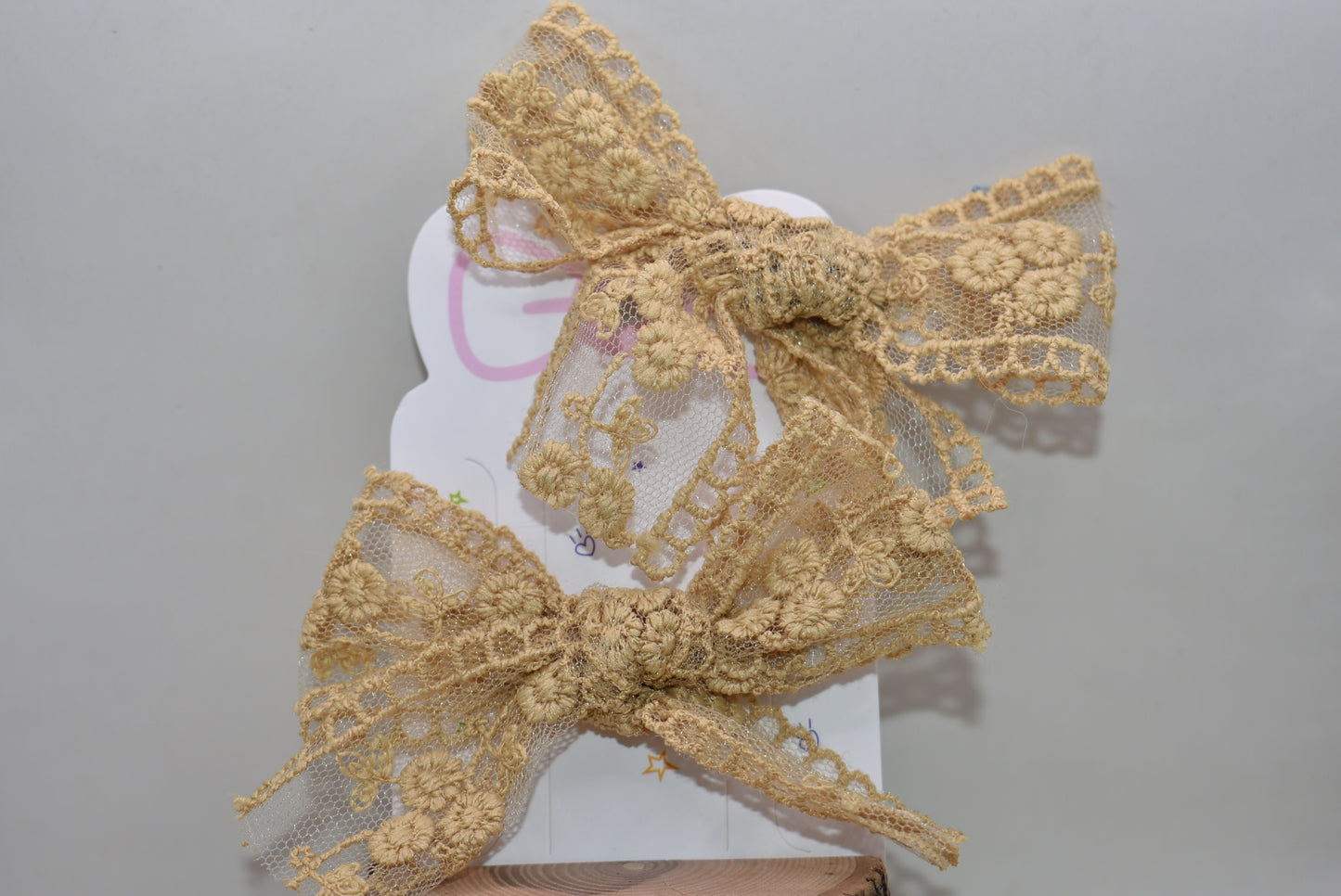 Elevate your accessory game with these stunning gold lace bows! This charming set of two brings instant elegance to any hairstyle, outfit, or creative project. Crafted with delicate lace detailing and a luxe gold finish, they're perfect for adding a touch of sophistication to everyday looks or special occasions. Whether you're styling up for a night out or adding flair to a gift, these versatile bows deliver major charm in a petite package. Double the bows, double the fun!