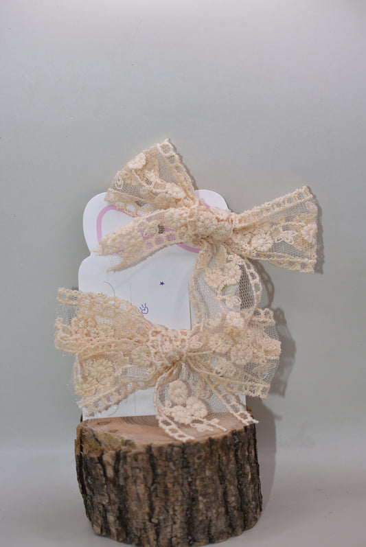 Elevate your style with these darling cream and off-white lace bows—a dynamic duo perfect for adding a touch of romantic flair to any look. Whether you're styling your hair, accessorizing a gift, or decorating a special occasion, these delicate bows bring instant charm and sophistication. The timeless lace detailing pairs beautifully with any outfit, making them go-to pieces for both everyday wear and memorable moments. With two bows in your collection, you'll always have the perfect finishing touch within 