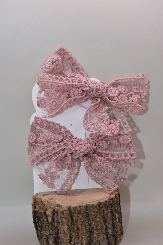 Elevate your style with this charming duo of dark mauve lace bows! Perfect for adding a touch of elegance to any look, these delicate bows feature intricate lace detailing that brings sophistication and whimsy together. Whether you're styling your hair, accessorizing a gift, or decorating a special occasion, these versatile beauties work magic. The rich mauve hue pairs beautifully with any color palette, making them a go-to accessory for fashion lovers who appreciate the finer details. Get both bows and dou