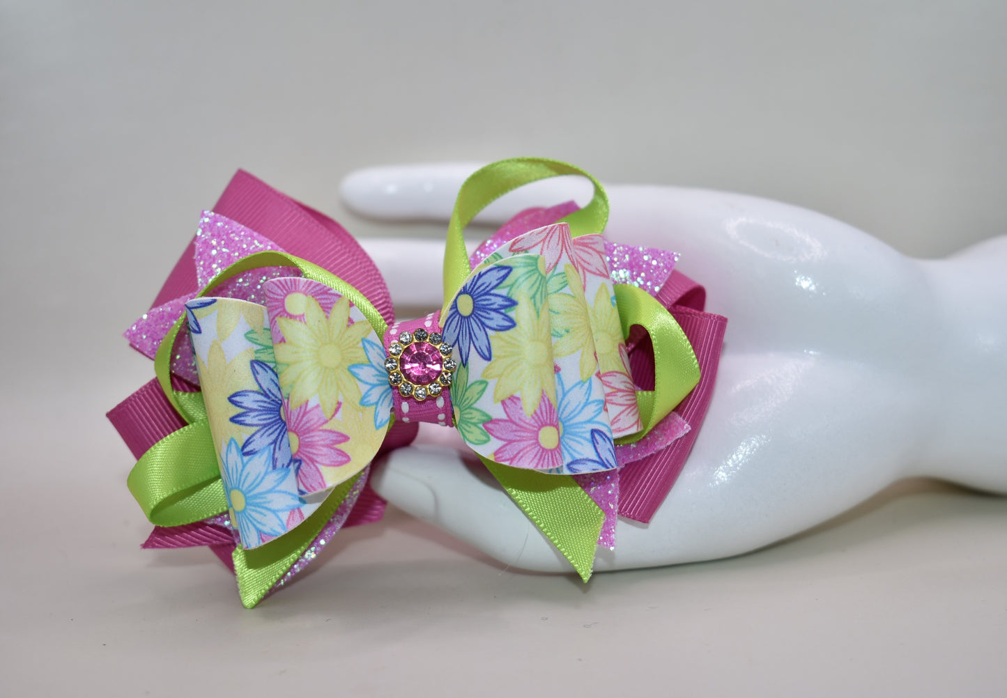 ✨ Get ready to turn heads with this absolutely gorgeous pink floral bow! 🌸 Featuring layers upon layers of silky ribbon for that full, fabulous look, this beauty is topped with a sparkling pink crystal charm that catches the light just right. 💎 The wrapped alligator clip on the back keeps everything secure and comfy all day long, so you can rock this charming accessory without a worry. Perfect for adding a touch of elegance and sparkle to any hairstyle! 🎀