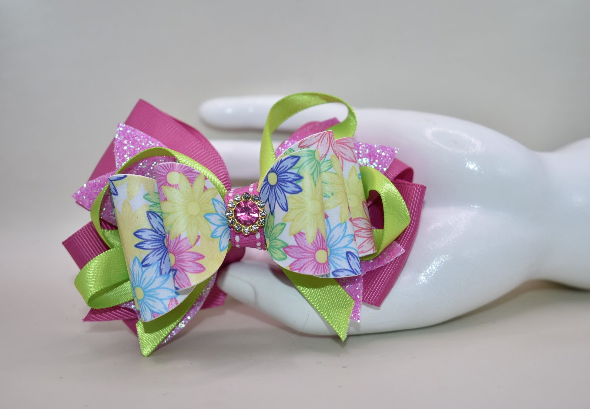 ✨ Get ready to turn heads with this absolutely gorgeous pink floral bow! 🌸 Featuring layers upon layers of silky ribbon for that full, fabulous look, this beauty is topped with a sparkling pink crystal charm that catches the light just right. 💎 The wrapped alligator clip on the back keeps everything secure and comfy all day long, so you can rock this charming accessory without a worry. Perfect for adding a touch of elegance and sparkle to any hairstyle! 🎀
