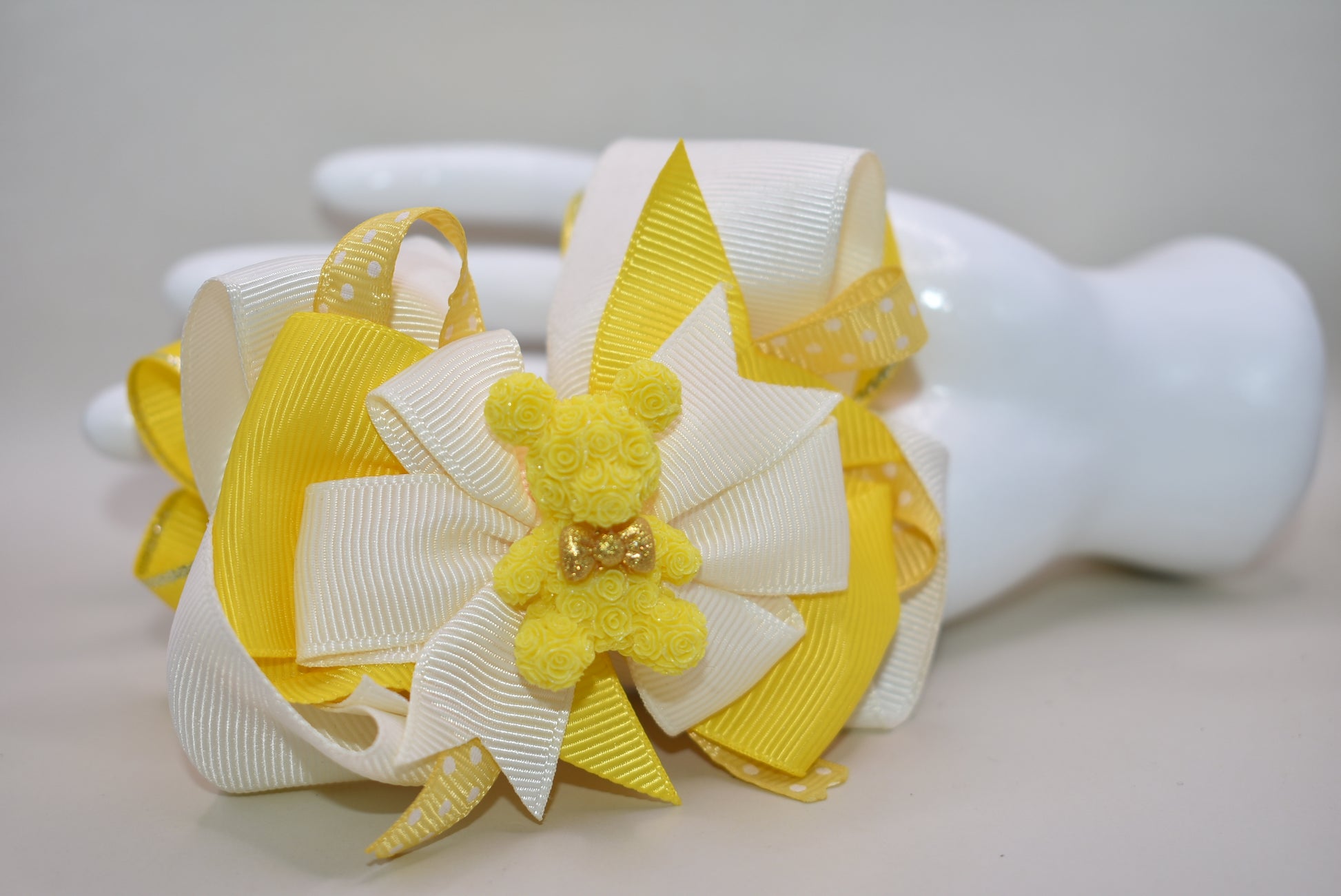 Get ready to brighten your day! ✨ This charming yellow bow is a must-have for yellow enthusiasts everywhere. 💛 Featuring an irresistibly cute yellow teddy bear with an adorable bow, this piece is layered with ribbons galore to make it absolutely one-of-a-kind. 🎀 The distinctive wrapped alligator claw on the back adds that extra touch of personality and charm. A playful treasure that's sure to make you smile! 🧸😊