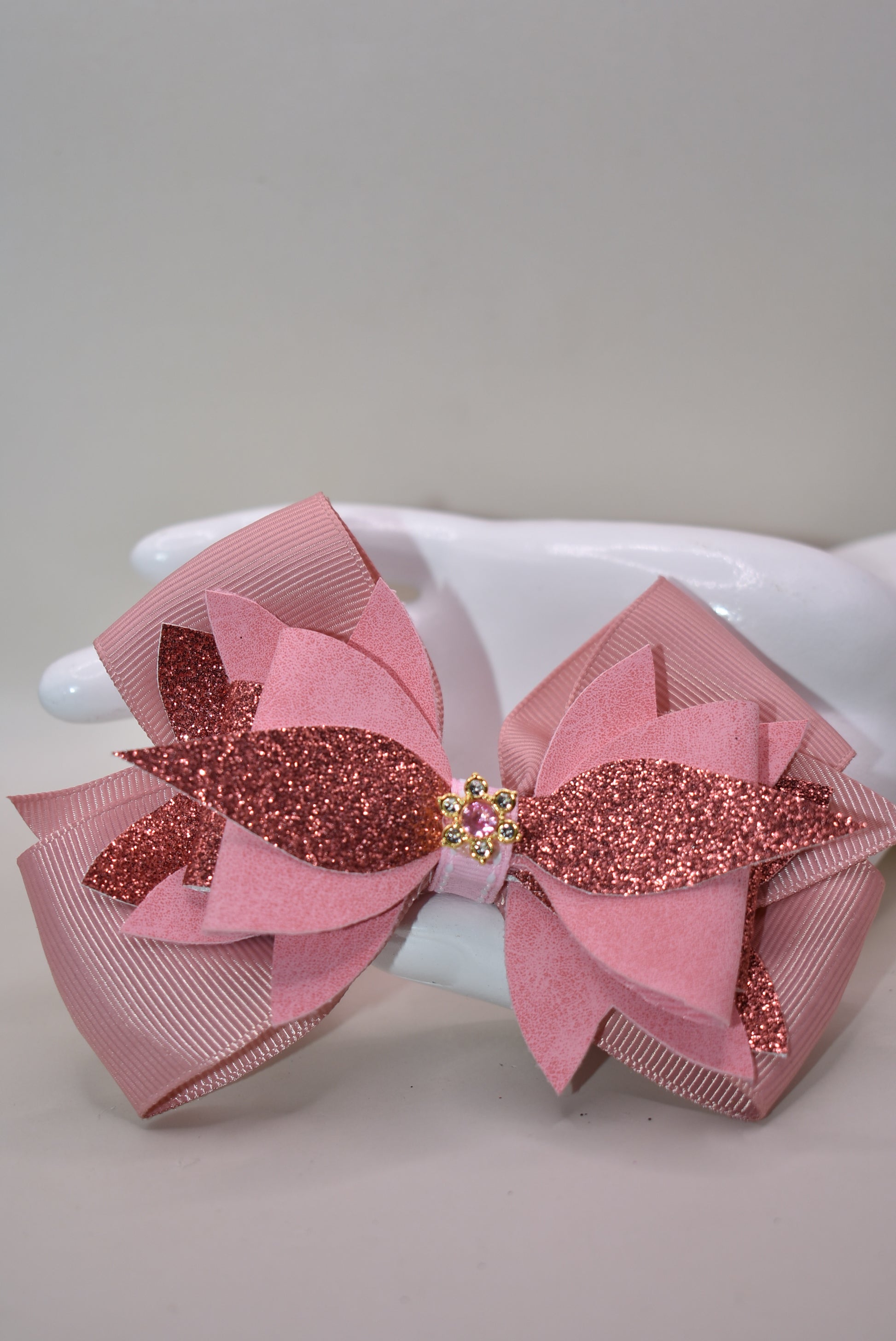 ✨ Meet your new go-to accessory! This one-of-a-kind bow blends rose gold faux leather and suede with delicate ribbon details, topped with an adorable charm that steals the show. 🎀 The perfect mix of shiny and soft textures makes it versatile enough to dress up any outfit—whether you're going casual or glam. 💕 Looking for something different? This is it! 🌹