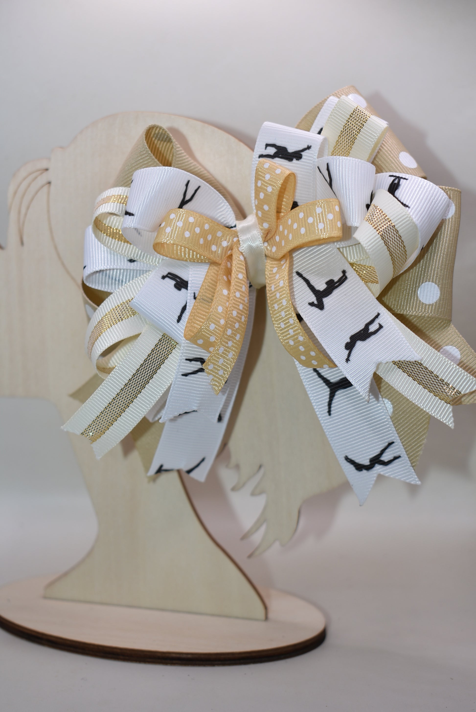 ✨ Let your little dancer shine with this gorgeous bow from Nana's Collection! Featuring luxurious layers of ribbon in soft cream, crisp white, and classic black, it's the perfect neutral accessory that pairs beautifully with any outfit. Whether she's heading to dance class, a special event, or just twirling around the house, this elegant bow adds that extra touch of charm and sophistication. 🎀 Watch her confidence bloom with every graceful move! 💕