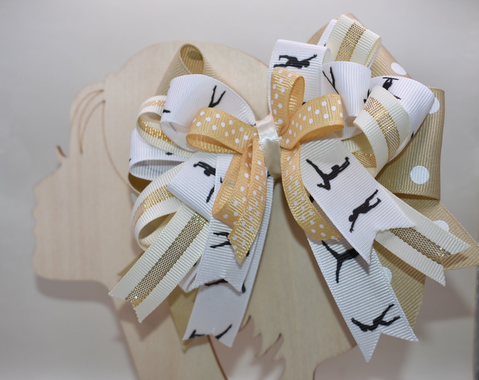 ✨ Let your little dancer shine with this gorgeous bow from Nana's Collection! Featuring luxurious layers of ribbon in soft cream, crisp white, and classic black, it's the perfect neutral accessory that pairs beautifully with any outfit. Whether she's heading to dance class, a special event, or just twirling around the house, this elegant bow adds that extra touch of charm and sophistication. 🎀 Watch her confidence bloom with every graceful move! 💕