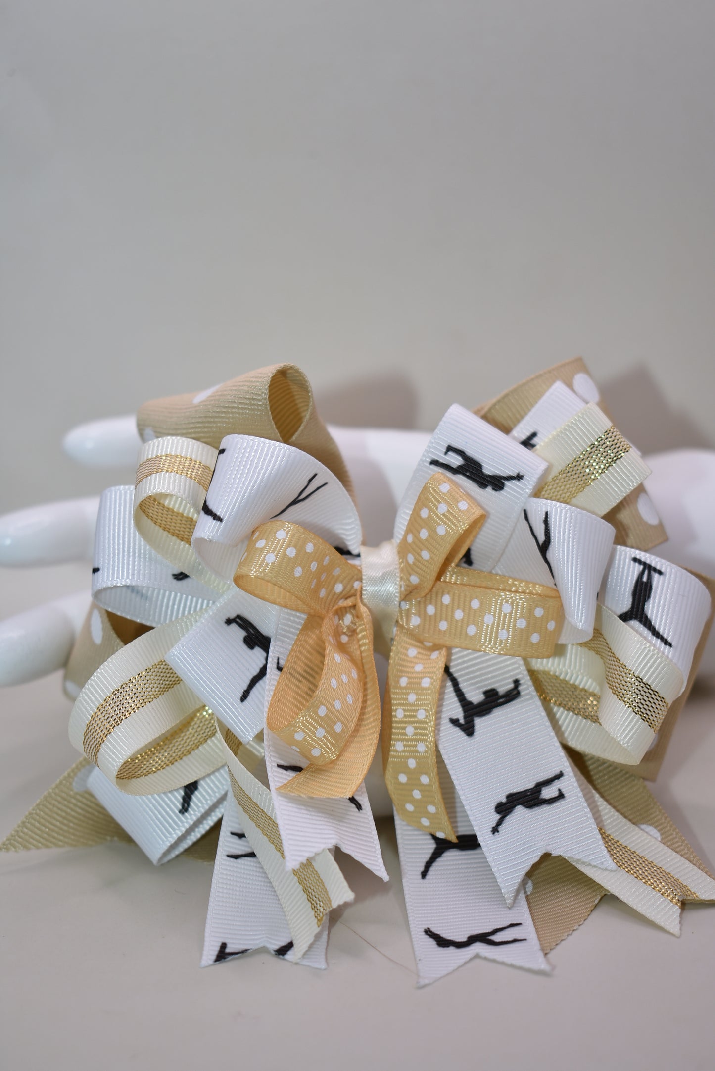 ✨ Let your little dancer shine with this gorgeous bow from Nana's Collection! Featuring luxurious layers of ribbon in soft cream, crisp white, and classic black, it's the perfect neutral accessory that pairs beautifully with any outfit. Whether she's heading to dance class, a special event, or just twirling around the house, this elegant bow adds that extra touch of charm and sophistication. 🎀 Watch her confidence bloom with every graceful move! 💕
