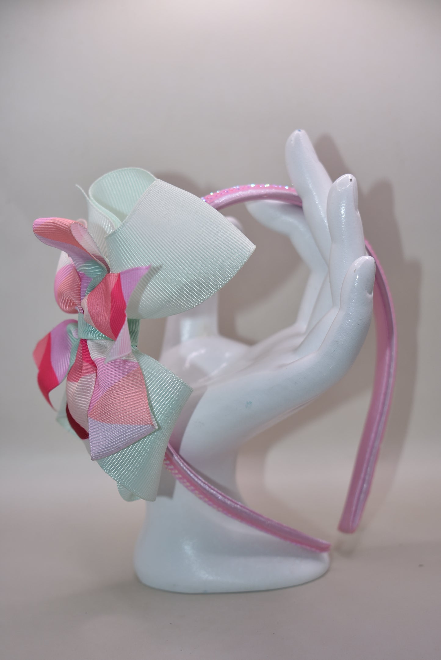 ✨ Step into style with this charming multi-colored headband that brings a pop of personality to any look! Featuring gorgeous pastel hues beautifully blended together and finished with a delicate pink sparkle accent on soft satin, this headband is as pretty as it is practical. The flexible design ensures all-day comfort, whether you're running errands, heading to an event, or just keeping your hair in place with flair. 🎀 Perfect for adding that extra touch of whimsy to your everyday style! 💕