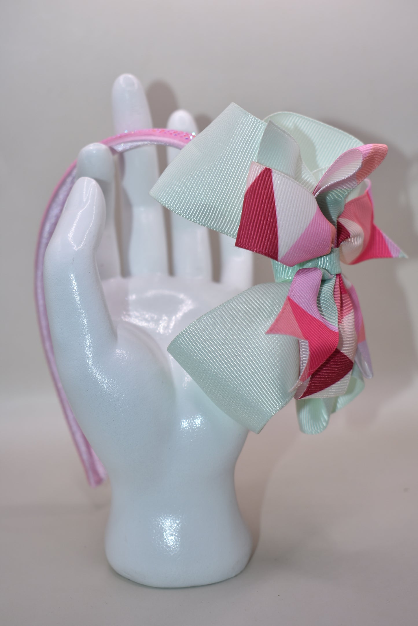 ✨ Step into style with this charming multi-colored headband that brings a pop of personality to any look! Featuring gorgeous pastel hues beautifully blended together and finished with a delicate pink sparkle accent on soft satin, this headband is as pretty as it is practical. The flexible design ensures all-day comfort, whether you're running errands, heading to an event, or just keeping your hair in place with flair. 🎀 Perfect for adding that extra touch of whimsy to your everyday style! 💕