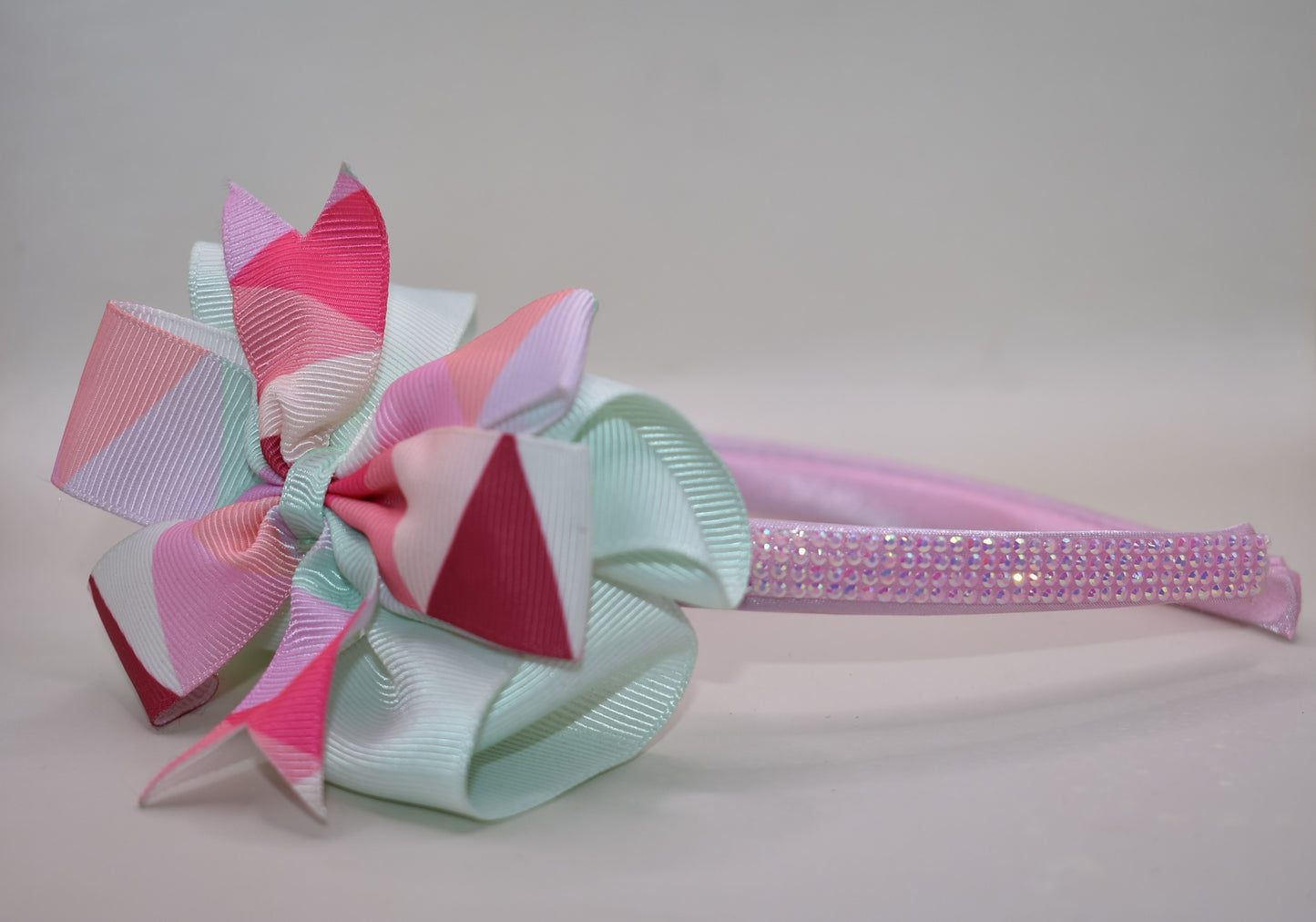 ✨ Step into style with this charming multi-colored headband that brings a pop of personality to any look! Featuring gorgeous pastel hues beautifully blended together and finished with a delicate pink sparkle accent on soft satin, this headband is as pretty as it is practical. The flexible design ensures all-day comfort, whether you're running errands, heading to an event, or just keeping your hair in place with flair. 🎀 Perfect for adding that extra touch of whimsy to your everyday style! 💕