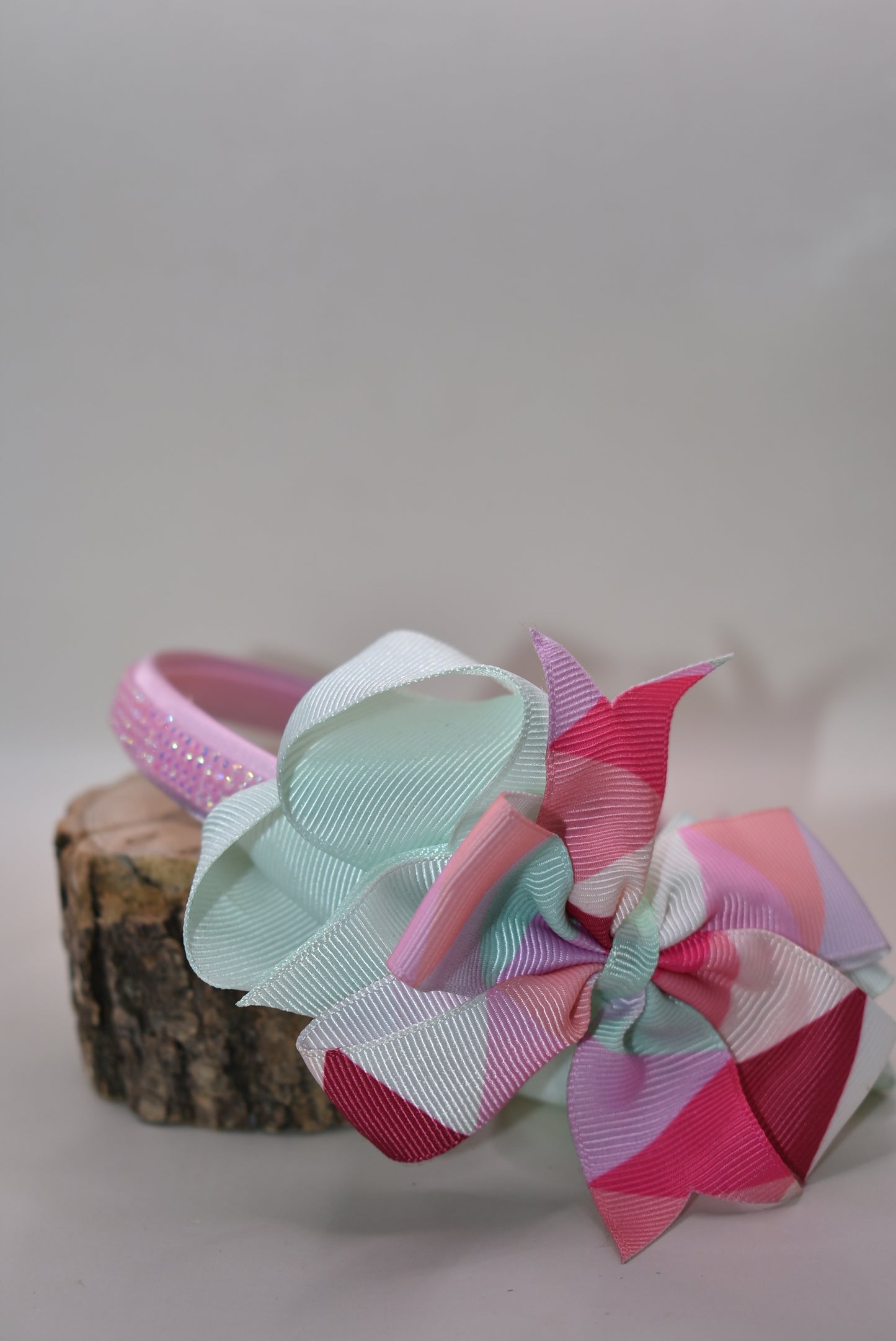 ✨ Step into style with this charming multi-colored headband that brings a pop of personality to any look! Featuring gorgeous pastel hues beautifully blended together and finished with a delicate pink sparkle accent on soft satin, this headband is as pretty as it is practical. The flexible design ensures all-day comfort, whether you're running errands, heading to an event, or just keeping your hair in place with flair. 🎀 Perfect for adding that extra touch of whimsy to your everyday style! 💕