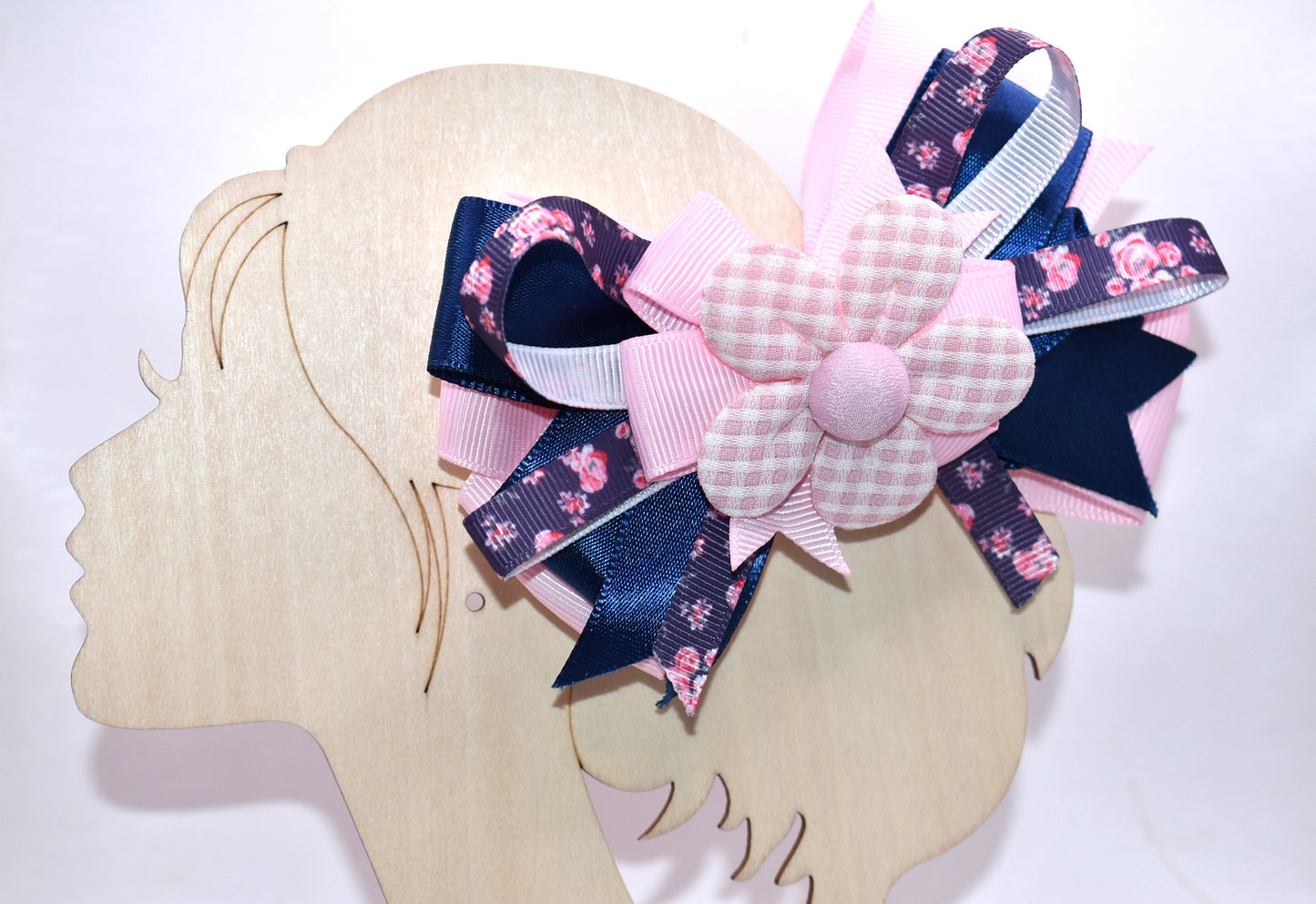 Get ready to spring into style with this one-of-a-kind bow! 🌸 Layers upon layers of gorgeous ribbon create dimension and movement, while an adorable checkered flower sits pretty on top for that perfect finishing touch. ✨ The wrapped alligator clip makes it effortless to wear—just clip and go! 🎀 This charming accessory is sure to have you falling head over heels. 💕