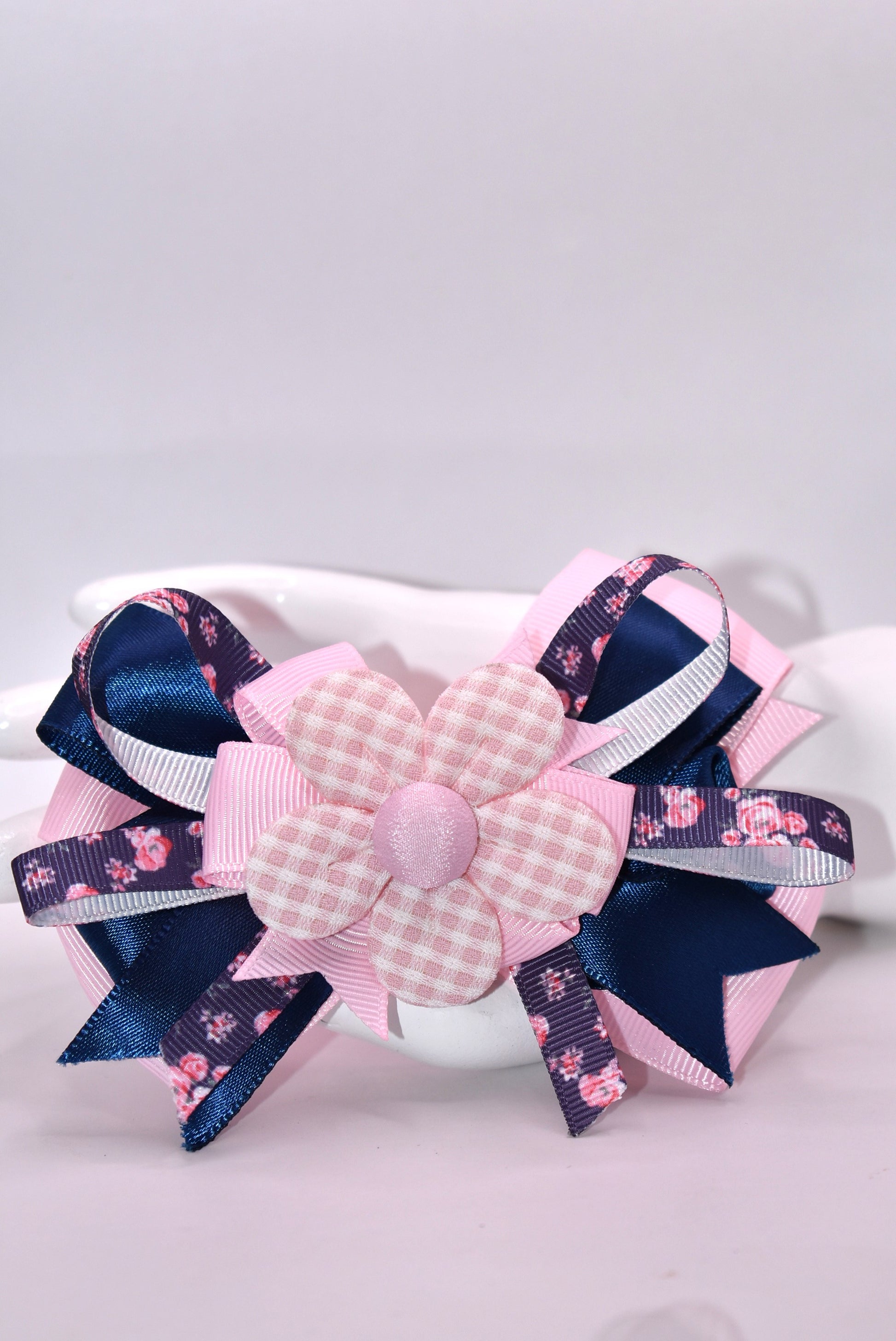 Get ready to spring into style with this one-of-a-kind bow! 🌸 Layers upon layers of gorgeous ribbon create dimension and movement, while an adorable checkered flower sits pretty on top for that perfect finishing touch. ✨ The wrapped alligator clip makes it effortless to wear—just clip and go! 🎀 This charming accessory is sure to have you falling head over heels. 💕
