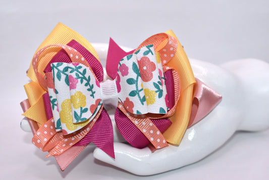 Get ready to turn heads with this adorable floral bow! 🌸 Bursting with pretty hues of orange, pink, and yellow, this charming accessory features delicate flowers, playful polka dots, and layers upon layers of ribbon for maximum cuteness. 🎀 The secure wrapped alligator clip keeps your style in place all day long. Perfect for adding a pop of color and personality to any look—you'll absolutely fall in love! 💕✨