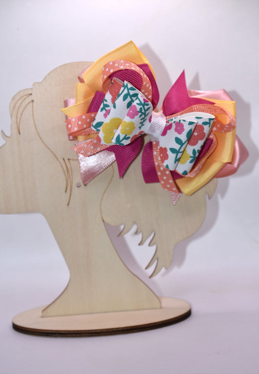 Get ready to turn heads with this adorable floral bow! 🌸 Bursting with pretty hues of orange, pink, and yellow, this charming accessory features delicate flowers, playful polka dots, and layers upon layers of ribbon for maximum cuteness. 🎀 The secure wrapped alligator clip keeps your style in place all day long. Perfect for adding a pop of color and personality to any look—you'll absolutely fall in love! 💕✨