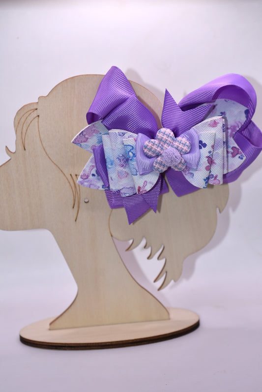 Elevate your bow game with this charming purple creation! 💜 Featuring a delightful floral design layered with rich purple ribbons, this bow brings instant personality to any hairstyle. The adorable purple flower topped with a fluffy pom pom adds that extra touch of whimsy. ✨ Wrapped in a secure alligator clip, it stays put all day long, so you can play, explore, and have fun without worry. Perfect for spring adventures! 🌸