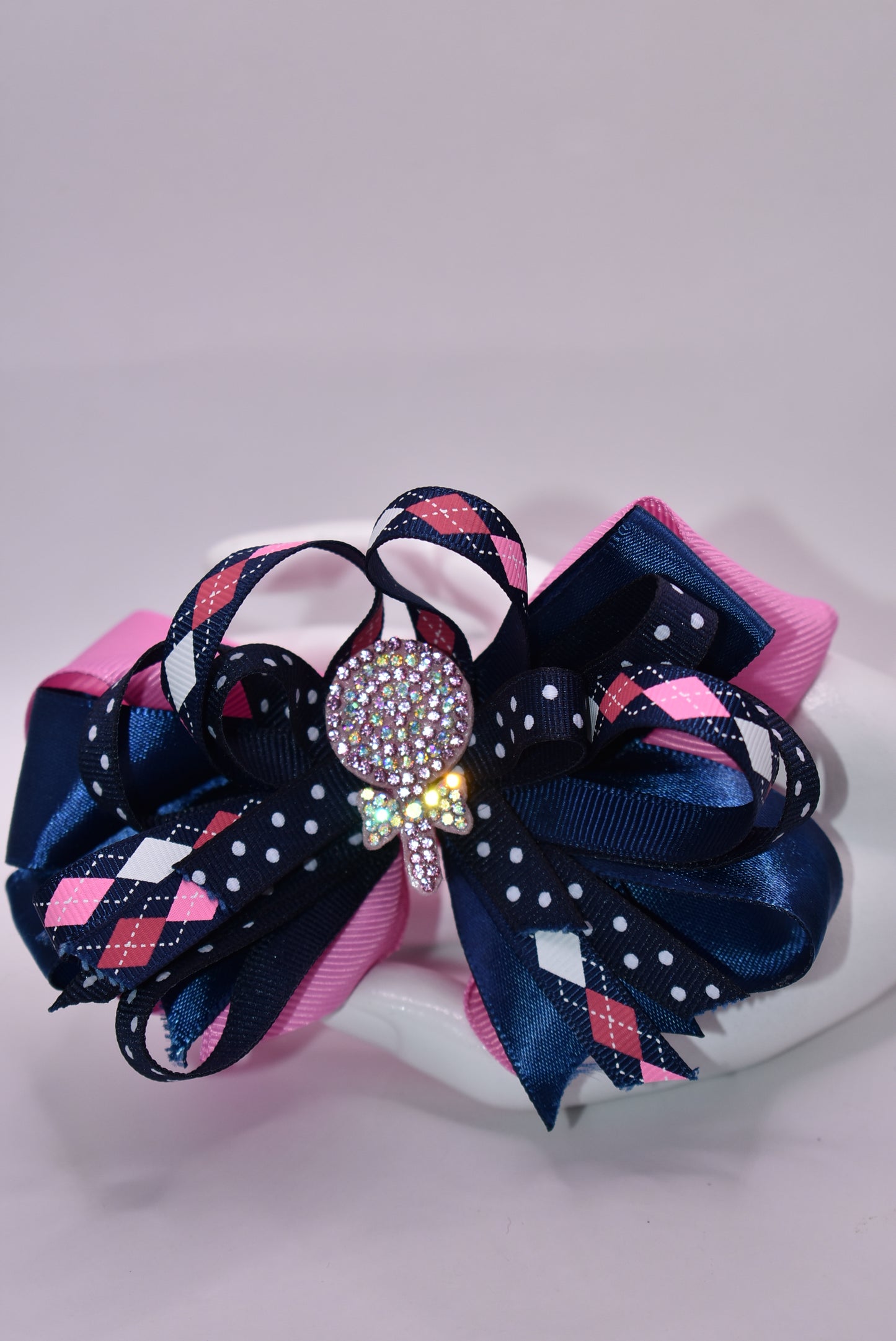 Introducing Nana's Collection A3 – a delightful accessory that's pure charm! 🎀 This adorable alligator clip features a gorgeous blend of pink and blue with beautifully layered ribbons that add dimension and style. ✨ Topped with a sparkling glitter candy charm, it's the perfect finishing touch for any hairstyle. 💖 Sweet, playful, and utterly enchanting – your little one will love showing it off! 🌈