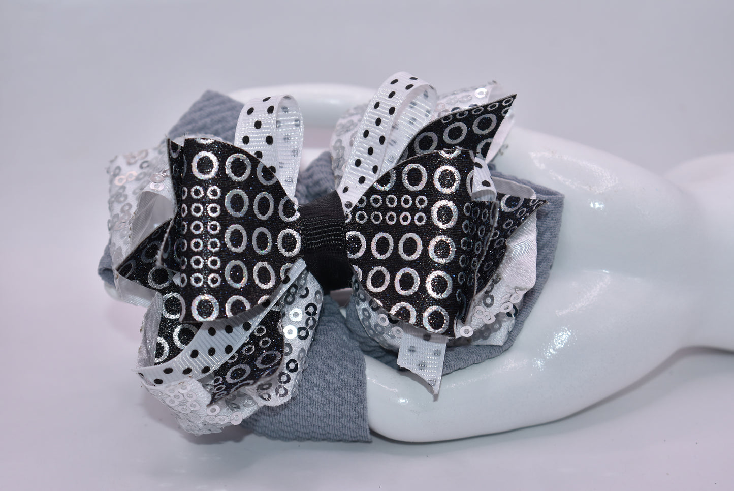✨ Stand out with Nana's Collection A4 – the bow that breaks the mold! 🎀 This stunning piece features a chic black, white, and silver palette that works together like magic. ✨ Packed with eye-catching shapes and sparkles that catch every light, it's the perfect accessory for anyone who dares to be different. 💫 The wrapped alligator clip slides on effortlessly, so you can rock this beauty all day long without a second thought. 🌟
