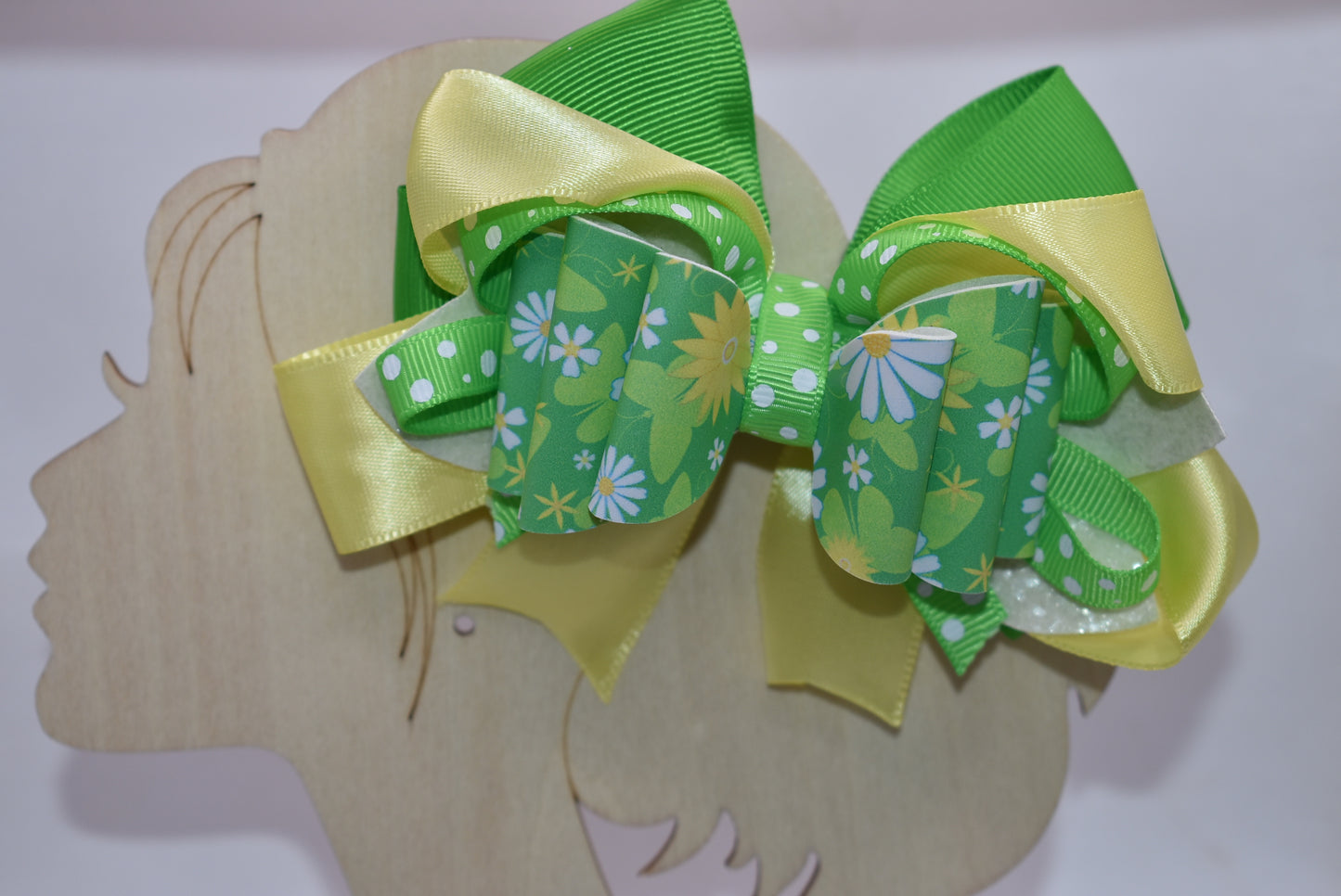 Brighten your style with this cheerful spring bow! 🌻 Bursting with vibrant green and yellow hues, it showcases a delightful blend of flower motifs and playful polka dots. The eye-catching design comes to life through layered ribbons and faux leather textures that add depth and movement. Secured with a wrapped alligator clip, it's ready to wear whenever inspiration strikes. 🎀 Your wardrobe just got a whole lot more fun! ✨💛