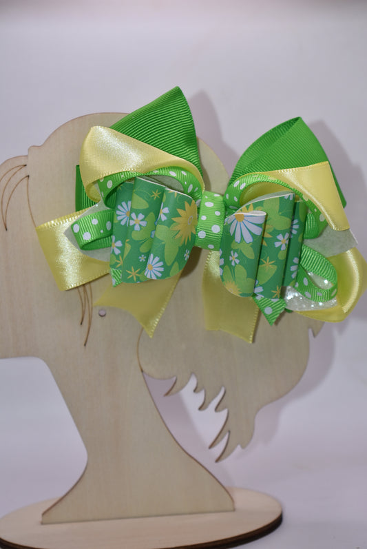 Brighten your style with this cheerful spring bow! 🌻 Bursting with vibrant green and yellow hues, it showcases a delightful blend of flower motifs and playful polka dots. The eye-catching design comes to life through layered ribbons and faux leather textures that add depth and movement. Secured with a wrapped alligator clip, it's ready to wear whenever inspiration strikes. 🎀 Your wardrobe just got a whole lot more fun! ✨💛