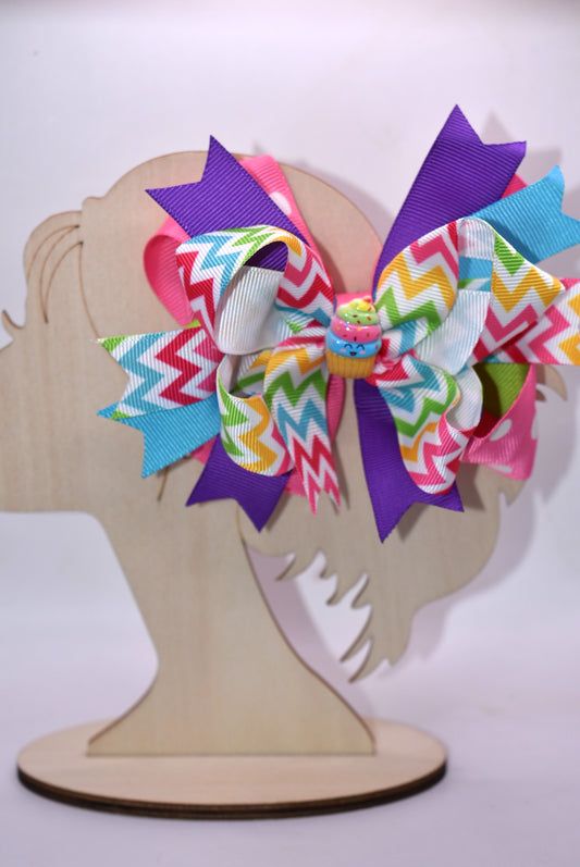 Sweeten your style with this delightful bow! 🎀✨ Featuring vibrant, layered bows adorned with ribbons in a rainbow of colors, this playful accessory brings instant charm to any look. A precious little cupcake charm perches on top, adding an extra touch of sugary sweetness. 🧁 The sturdy metal alligator clip makes styling effortless—just clip and go! Perfect for hair, bags, or anywhere you want to add a pop of fun and personality. 💕🌈