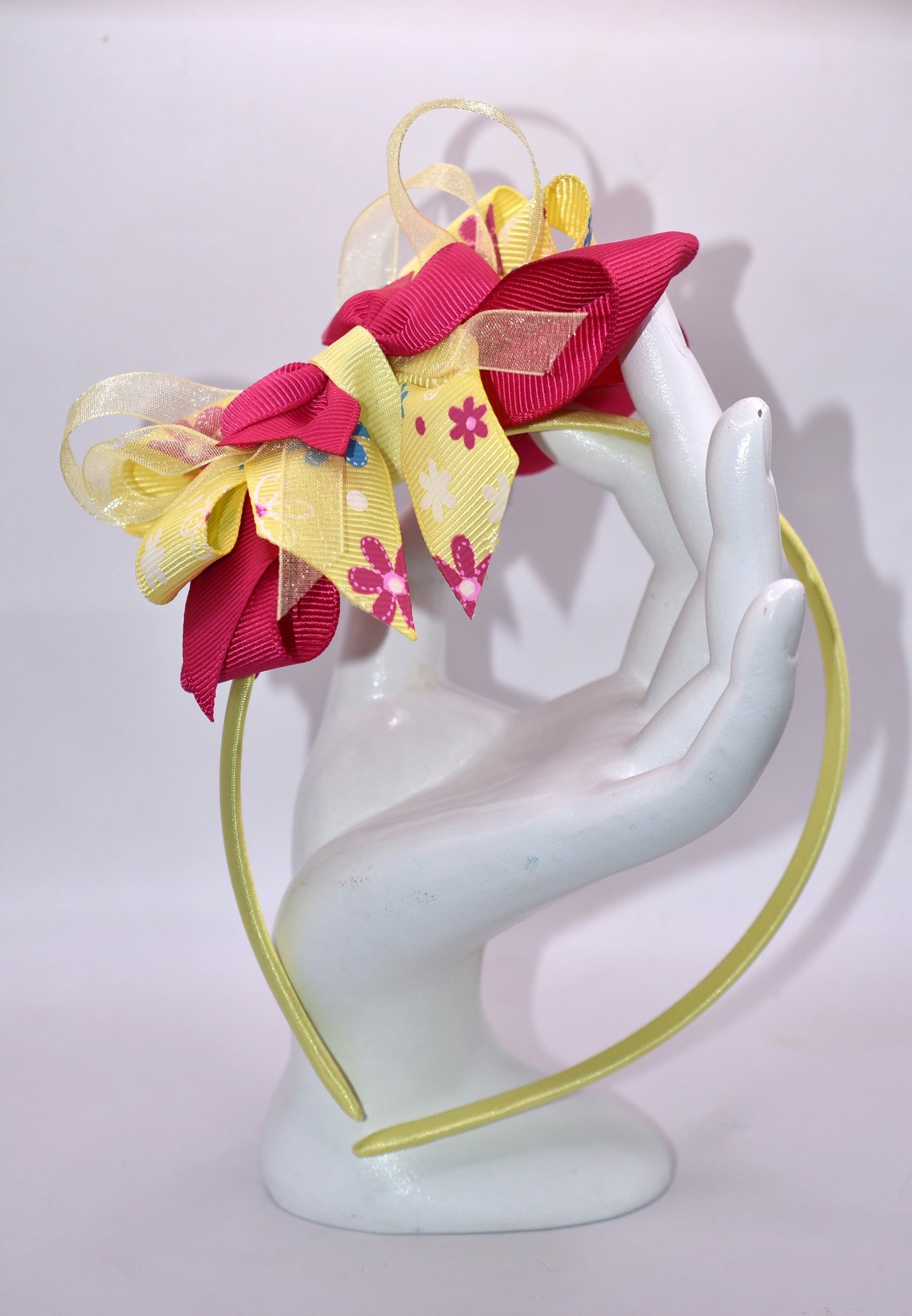 Elevate your style with this stunning bright pink and yellow floral headband! 🌸✨ Crafted from soft, flexible satin, it glides smoothly over your hair without tugging or discomfort. Whether you're heading to brunch, a special event, or just want to add pizzazz to your everyday look, this one-of-a-kind beauty keeps you feeling fabulous all day long. 💛💕 The perfect finishing touch that transforms any outfit from ordinary to absolutely gorgeous!