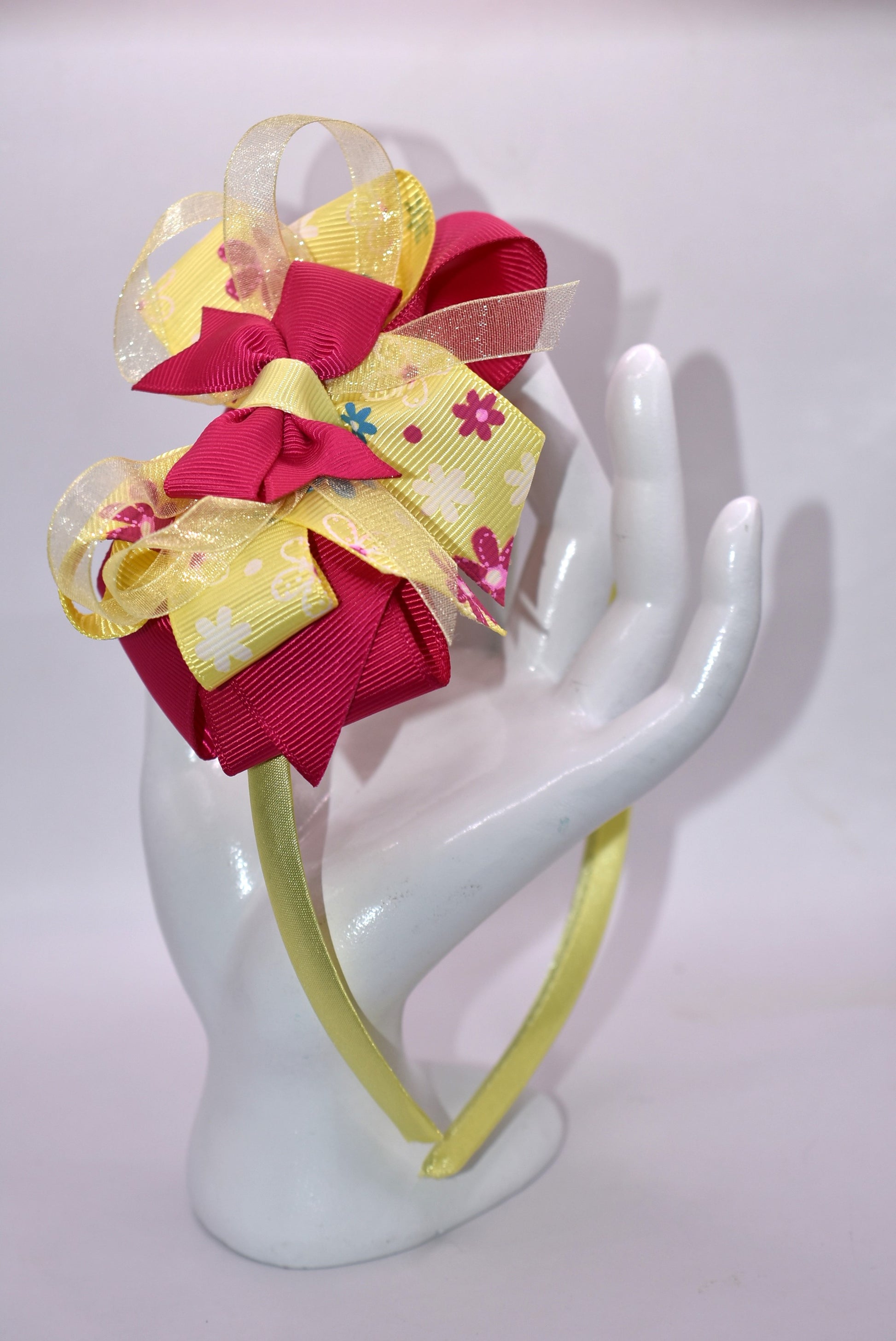 Elevate your style with this stunning bright pink and yellow floral headband! 🌸✨ Crafted from soft, flexible satin, it glides smoothly over your hair without tugging or discomfort. Whether you're heading to brunch, a special event, or just want to add pizzazz to your everyday look, this one-of-a-kind beauty keeps you feeling fabulous all day long. 💛💕 The perfect finishing touch that transforms any outfit from ordinary to absolutely gorgeous!