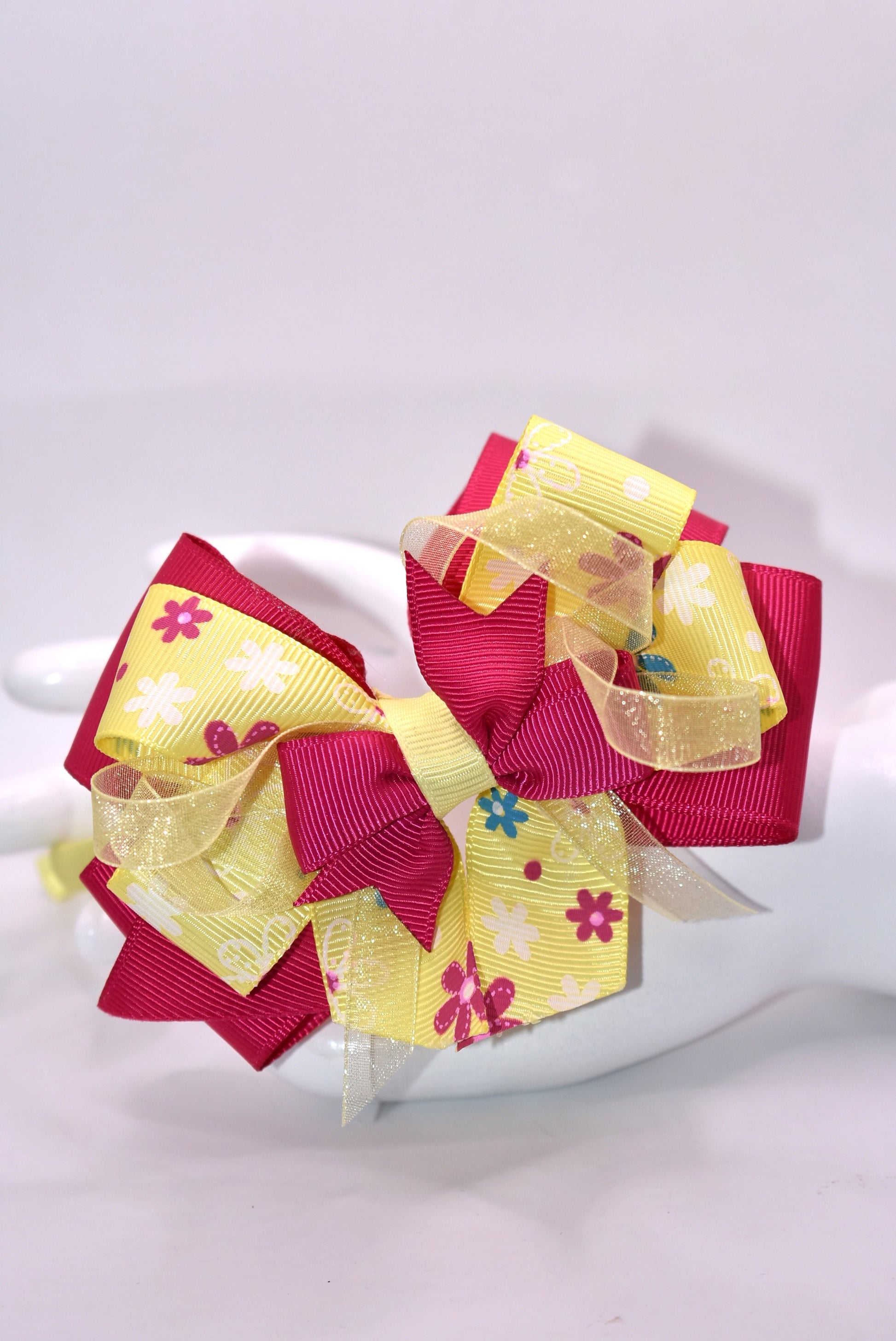 Elevate your style with this stunning bright pink and yellow floral headband! 🌸✨ Crafted from soft, flexible satin, it glides smoothly over your hair without tugging or discomfort. Whether you're heading to brunch, a special event, or just want to add pizzazz to your everyday look, this one-of-a-kind beauty keeps you feeling fabulous all day long. 💛💕 The perfect finishing touch that transforms any outfit from ordinary to absolutely gorgeous!
