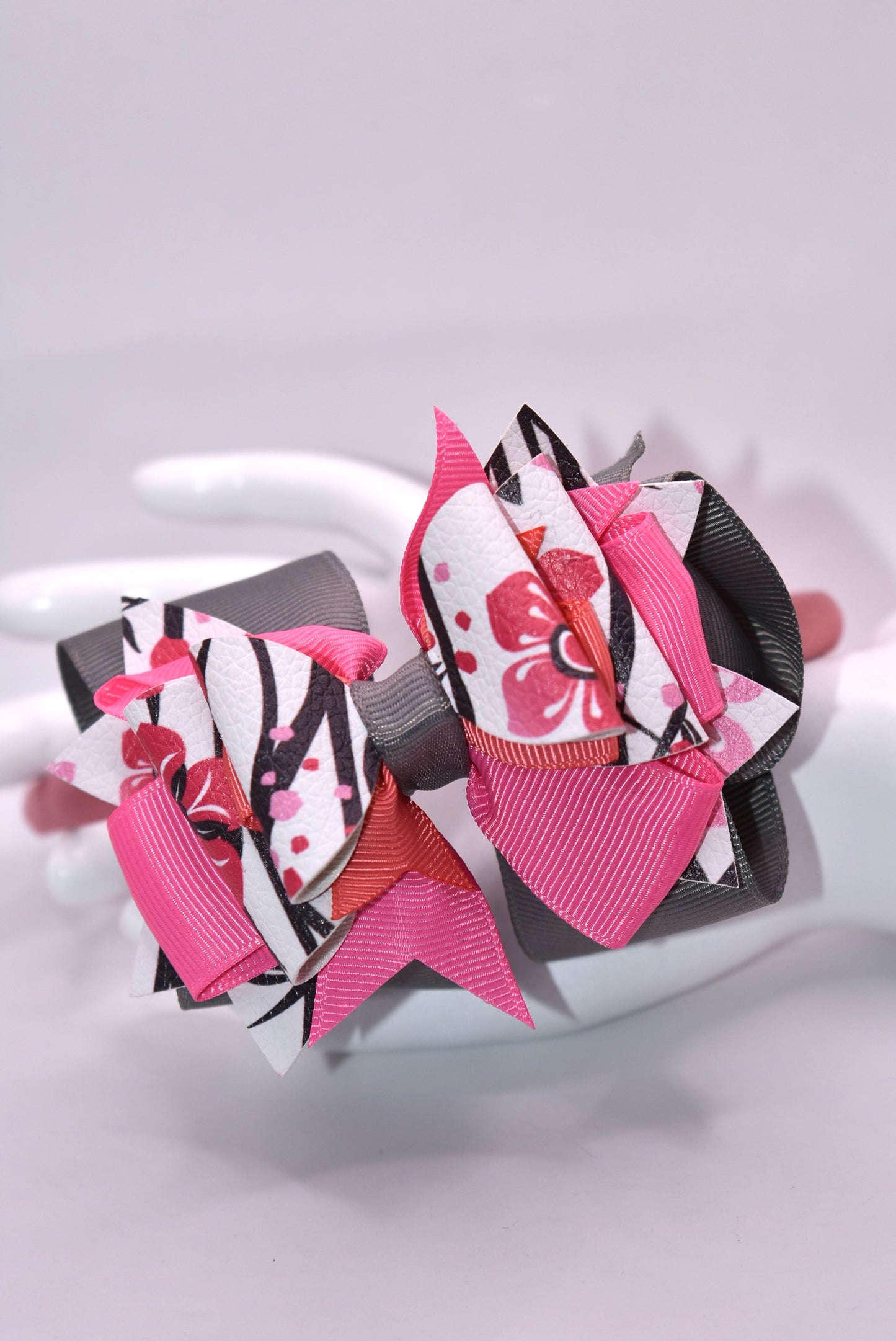 ✨ Slip into elegance with this stunning one-of-a-kind satin headband! 🎀 Crafted with luxurious layers of faux leather and grosgrain ribbon adorned with delicate floral details, this beauty is as comfortable as it is gorgeous. The thin, flexible satin design sits perfectly against your head without any pinching or slipping—you'll forget you're even wearing it! 💕 Whether you're dressing up for a special occasion or adding a touch of charm to your everyday look, this headband is the accessory you'll reach fo