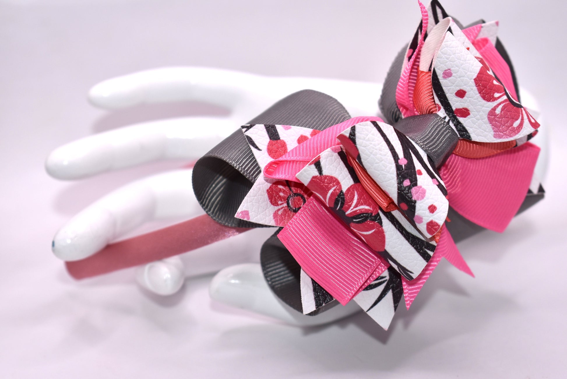 ✨ Slip into elegance with this stunning one-of-a-kind satin headband! 🎀 Crafted with luxurious layers of faux leather and grosgrain ribbon adorned with delicate floral details, this beauty is as comfortable as it is gorgeous. The thin, flexible satin design sits perfectly against your head without any pinching or slipping—you'll forget you're even wearing it! 💕 Whether you're dressing up for a special occasion or adding a touch of charm to your everyday look, this headband is the accessory you'll reach fo