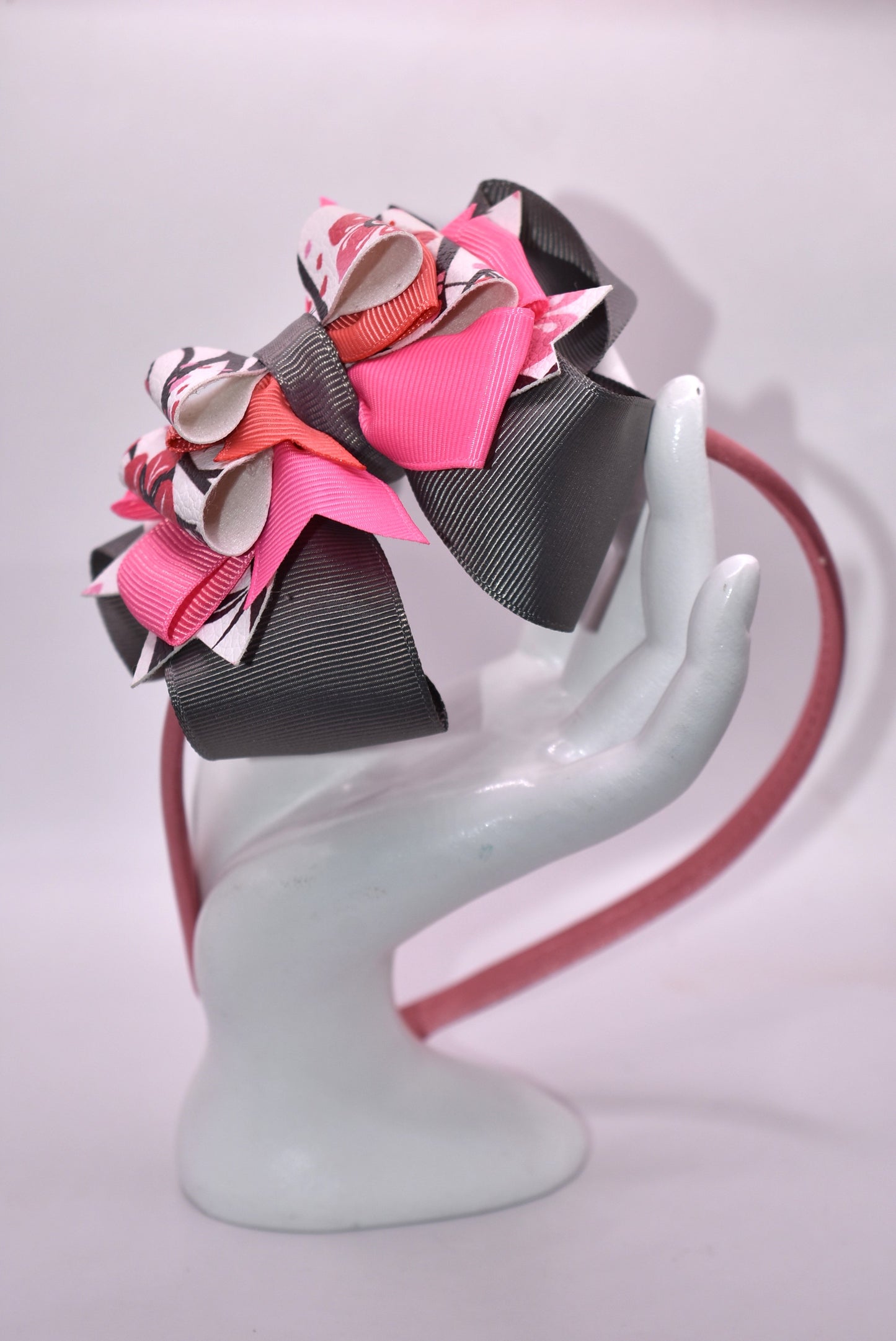 ✨ Slip into elegance with this stunning one-of-a-kind satin headband! 🎀 Crafted with luxurious layers of faux leather and grosgrain ribbon adorned with delicate floral details, this beauty is as comfortable as it is gorgeous. The thin, flexible satin design sits perfectly against your head without any pinching or slipping—you'll forget you're even wearing it! 💕 Whether you're dressing up for a special occasion or adding a touch of charm to your everyday look, this headband is the accessory you'll reach fo