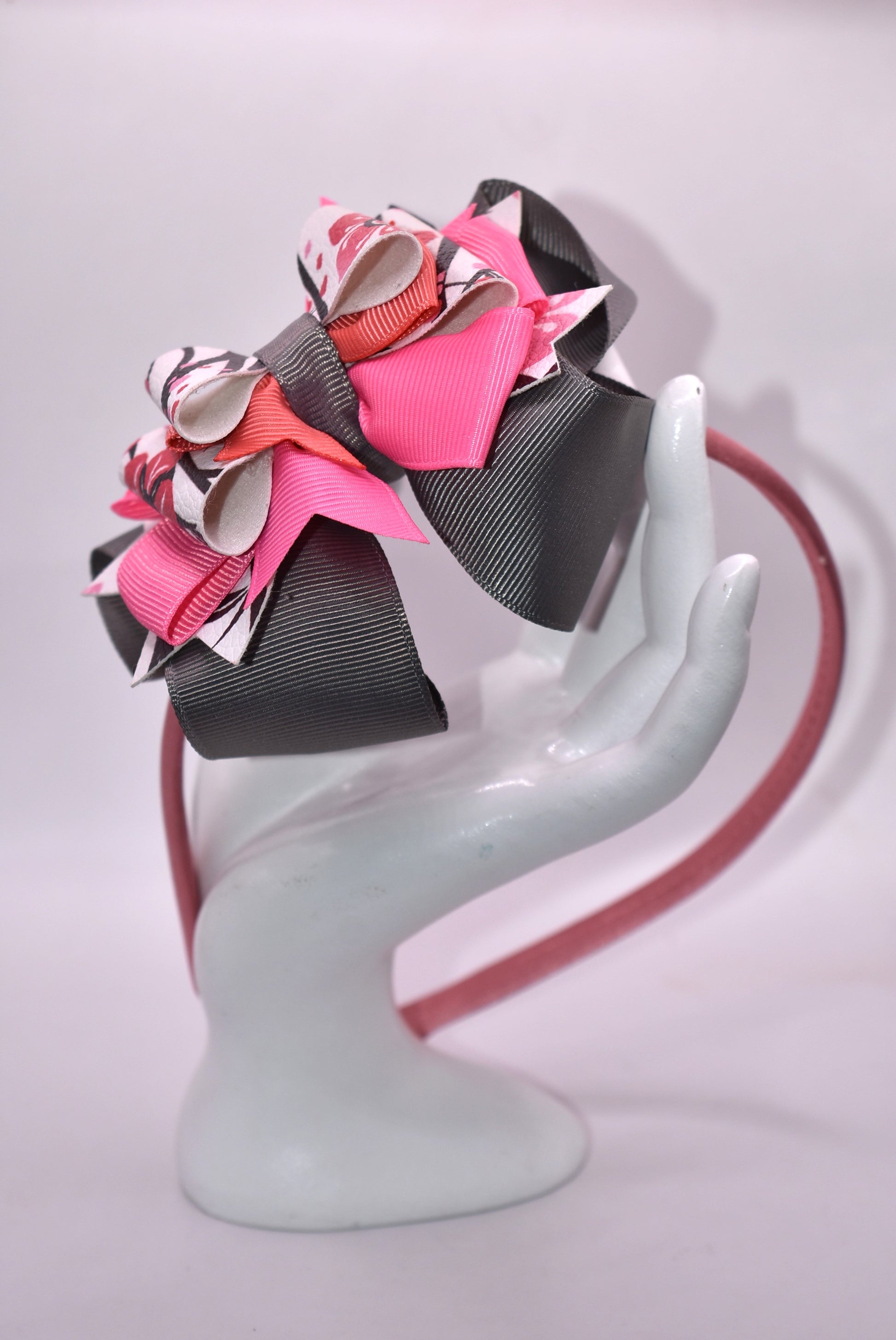 ✨ Slip into elegance with this stunning one-of-a-kind satin headband! 🎀 Crafted with luxurious layers of faux leather and grosgrain ribbon adorned with delicate floral details, this beauty is as comfortable as it is gorgeous. The thin, flexible satin design sits perfectly against your head without any pinching or slipping—you'll forget you're even wearing it! 💕 Whether you're dressing up for a special occasion or adding a touch of charm to your everyday look, this headband is the accessory you'll reach fo