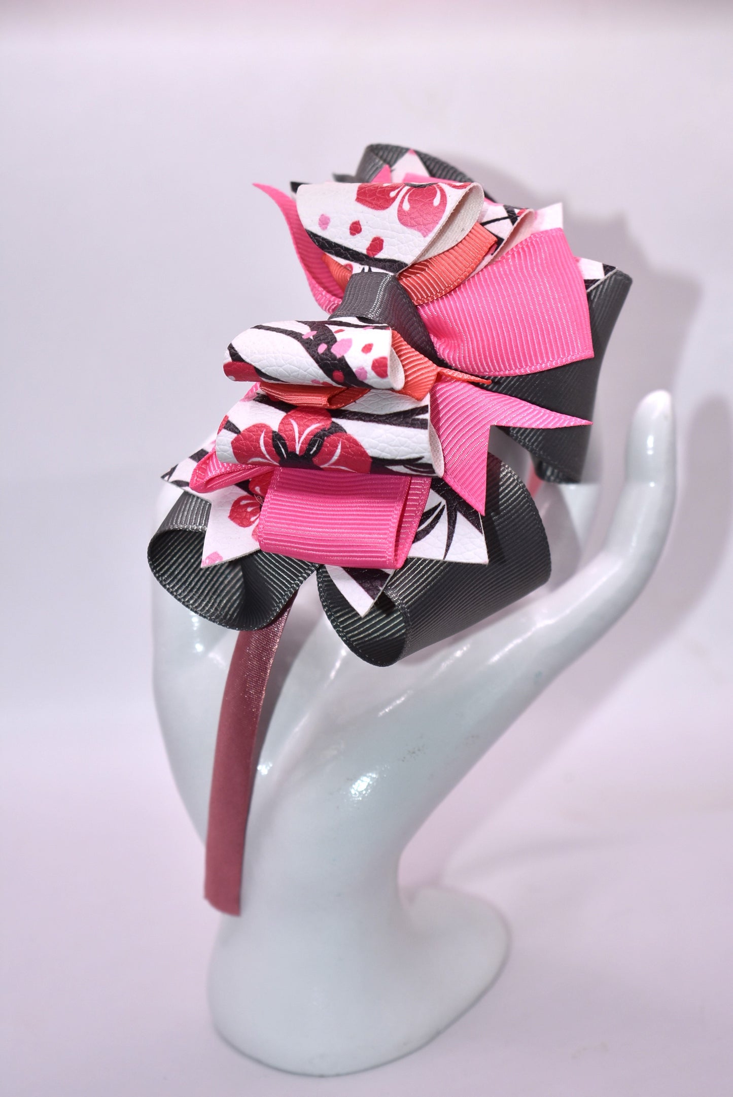 ✨ Slip into elegance with this stunning one-of-a-kind satin headband! 🎀 Crafted with luxurious layers of faux leather and grosgrain ribbon adorned with delicate floral details, this beauty is as comfortable as it is gorgeous. The thin, flexible satin design sits perfectly against your head without any pinching or slipping—you'll forget you're even wearing it! 💕 Whether you're dressing up for a special occasion or adding a touch of charm to your everyday look, this headband is the accessory you'll reach fo