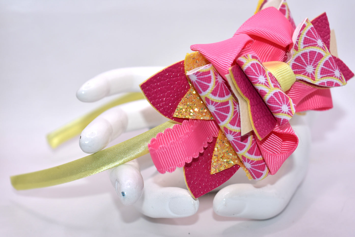 ✨ Introducing Nana's Headband Collection H2 – a one-of-a-kind accessory that's pure joy! 💕 This playful headband features luxurious layers of faux leather and grosgrain ribbon in gorgeous pink and yellow tones that'll brighten any day. The flexible yellow satin base ensures all-day comfort, while sparkling embellishments add that extra dash of fun and personality. 🎀 Whether you're dressing up or keeping it casual, this charming piece brings instant style and whimsy to your look. 🌟