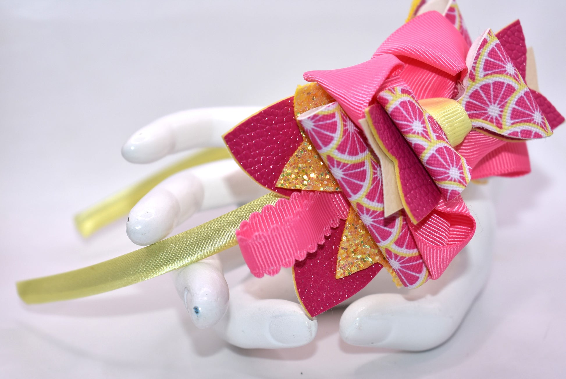 ✨ Introducing Nana's Headband Collection H2 – a one-of-a-kind accessory that's pure joy! 💕 This playful headband features luxurious layers of faux leather and grosgrain ribbon in gorgeous pink and yellow tones that'll brighten any day. The flexible yellow satin base ensures all-day comfort, while sparkling embellishments add that extra dash of fun and personality. 🎀 Whether you're dressing up or keeping it casual, this charming piece brings instant style and whimsy to your look. 🌟