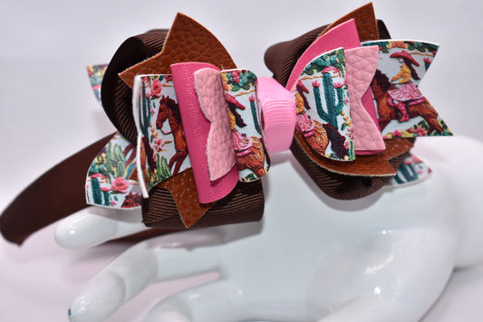 Saddle up, partner! 🤠 This one-of-a-kind headband brings serious cowgirl vibes with its charming faux leather and ribbon motif in gorgeous shades of brown and pink. 🌸 The wide silk construction keeps things comfy all day long, while the flexible design moves with you—no pinching, no fussing. Whether you're channeling your inner rodeo queen or just want to add some playful Western flair to your look, this beauty delivers style with zero compromise. 💕 Yeehaw!